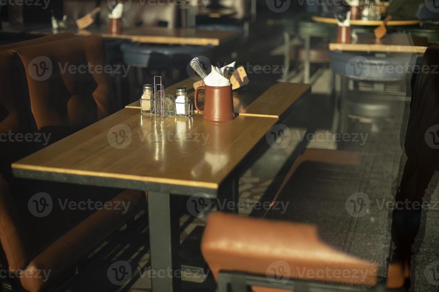 Table in restaurant. Place to relax. Brown sofa. Dining table. photo