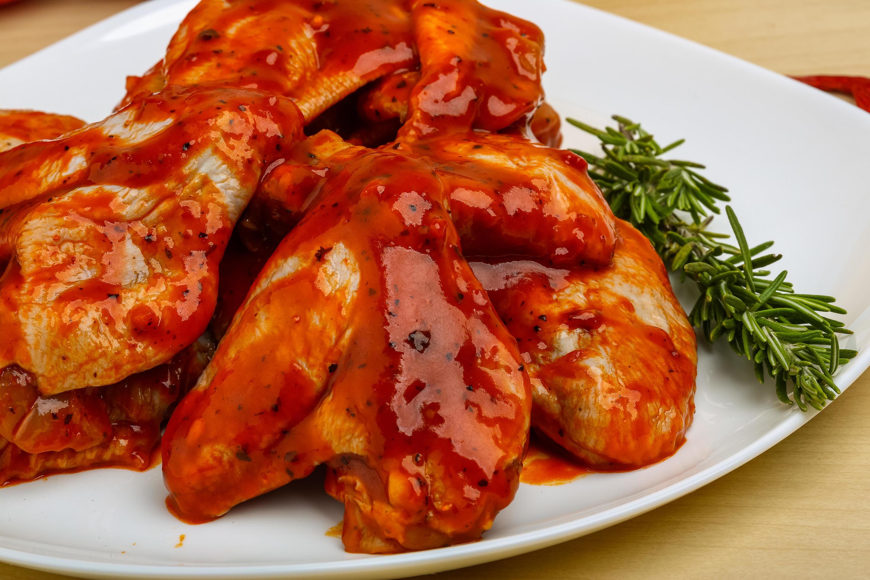 Chicken wings on the plate and wooden background 12272656 Stock Photo