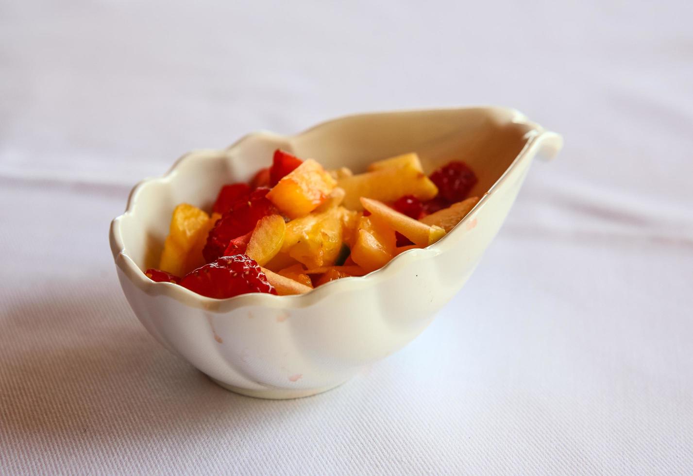 Fruit salad in a bowl on white background photo