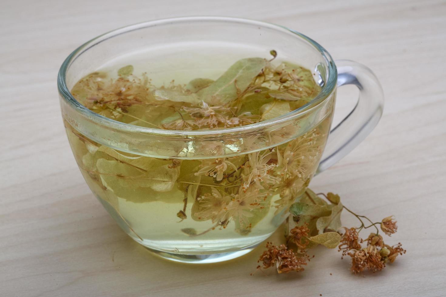 Linden tea on wooden background photo