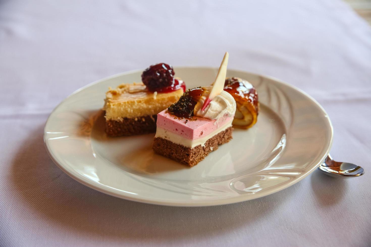 Mini cakes on the plate and white background photo