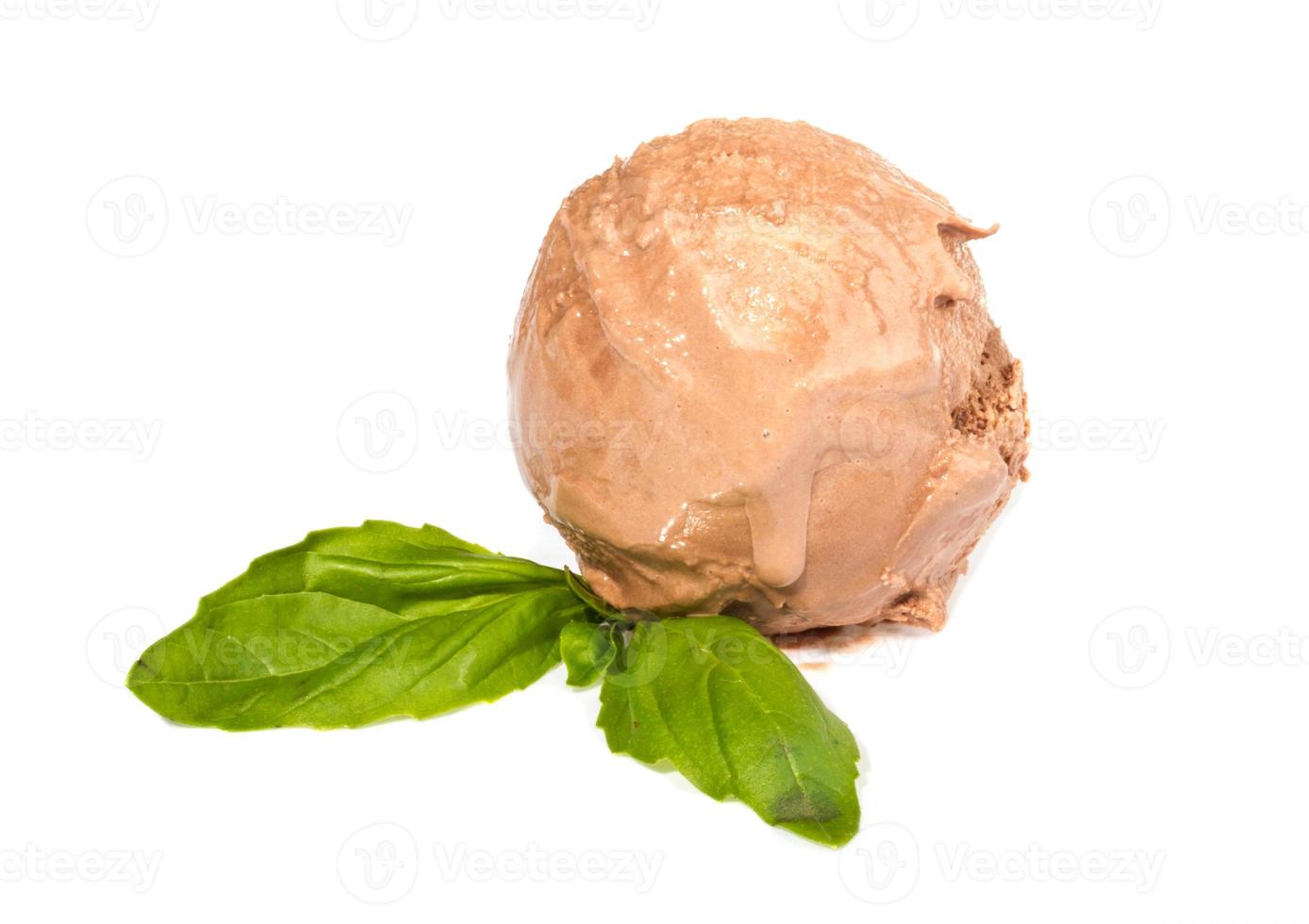 Scoop of chocolate ice cream with mint leaf photo