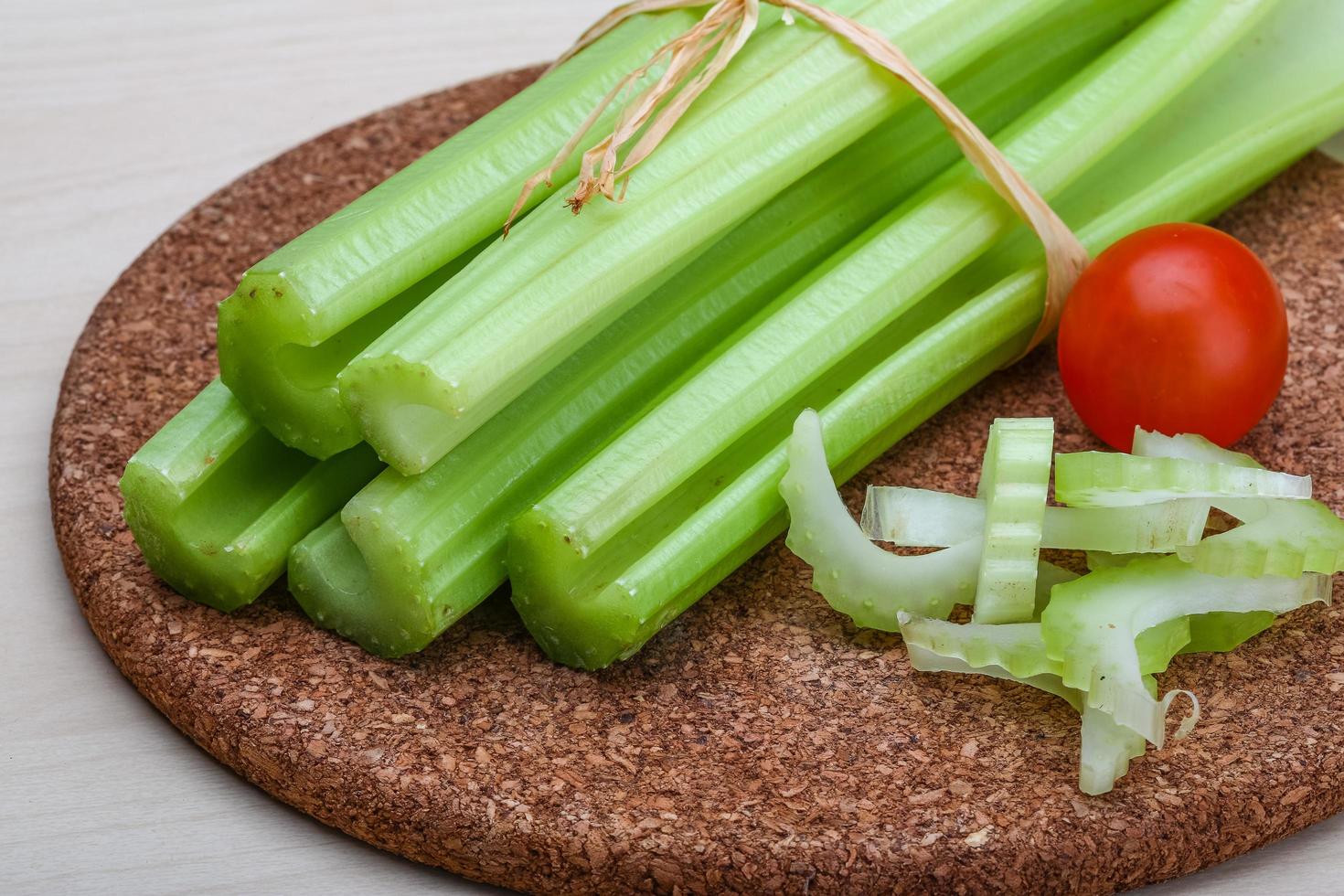 Celery on wooden board and wooden background photo