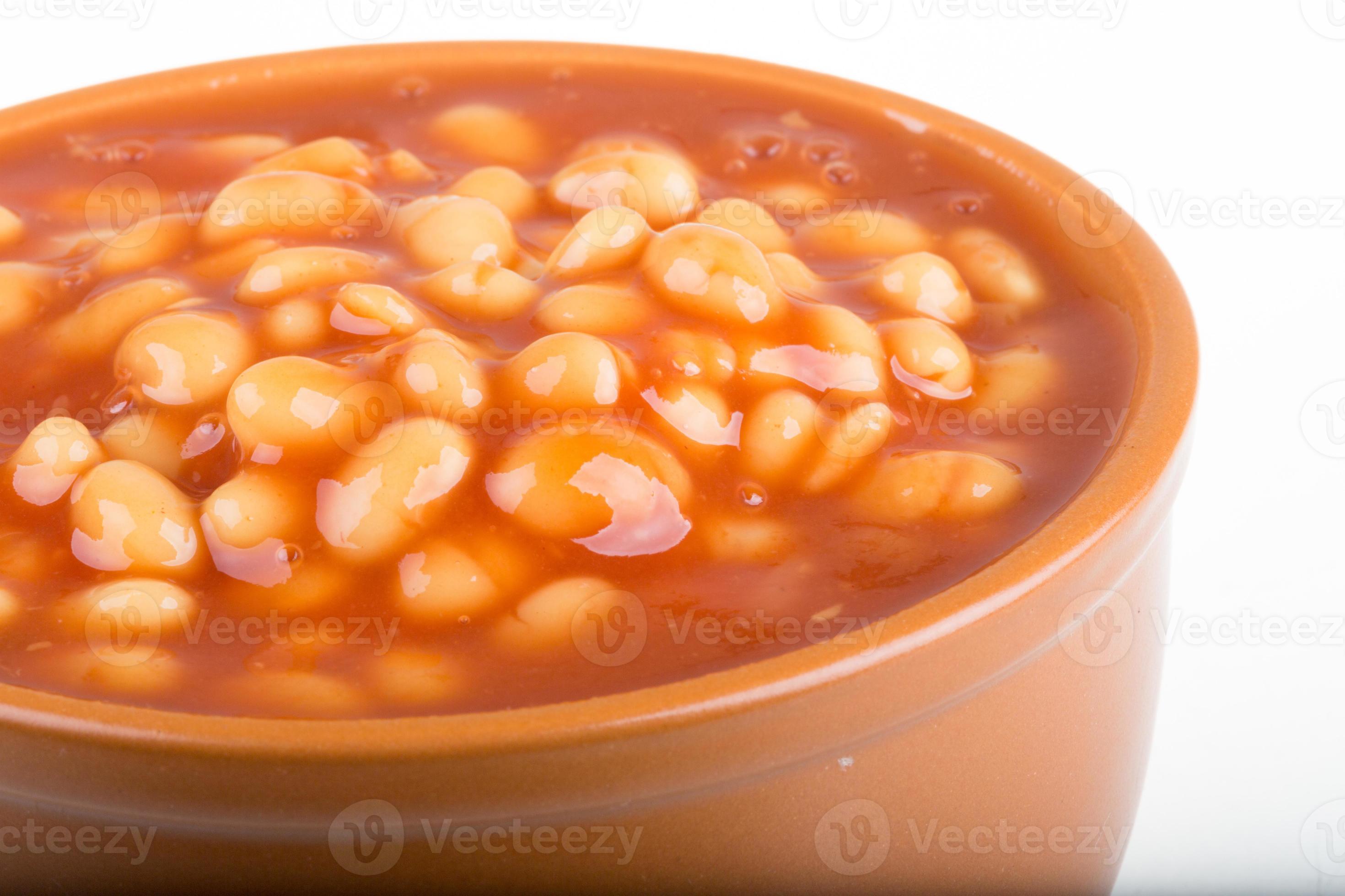 Marinated haricot beans in tomato sauce with shallots on a plate