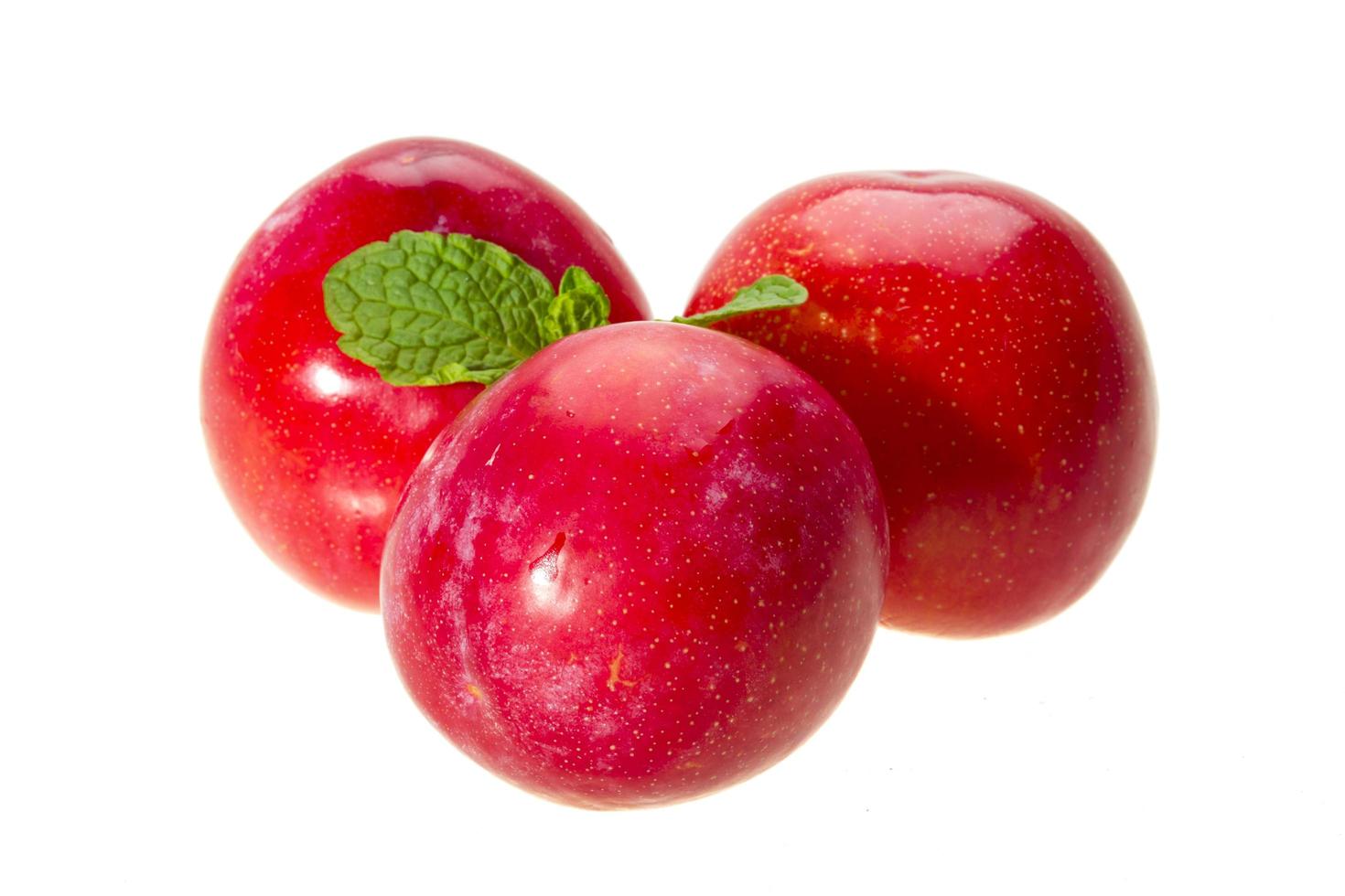 Bright ripe plum with mint photo