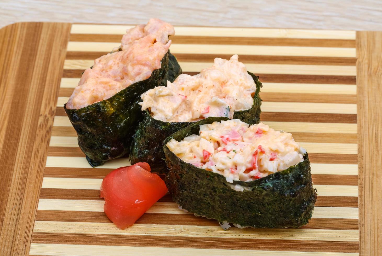 Gunkan sushi on wooden board and wooden background photo