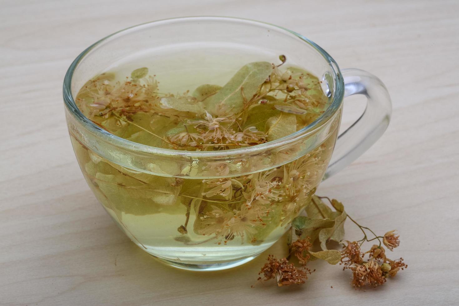 Linden tea on wooden background photo