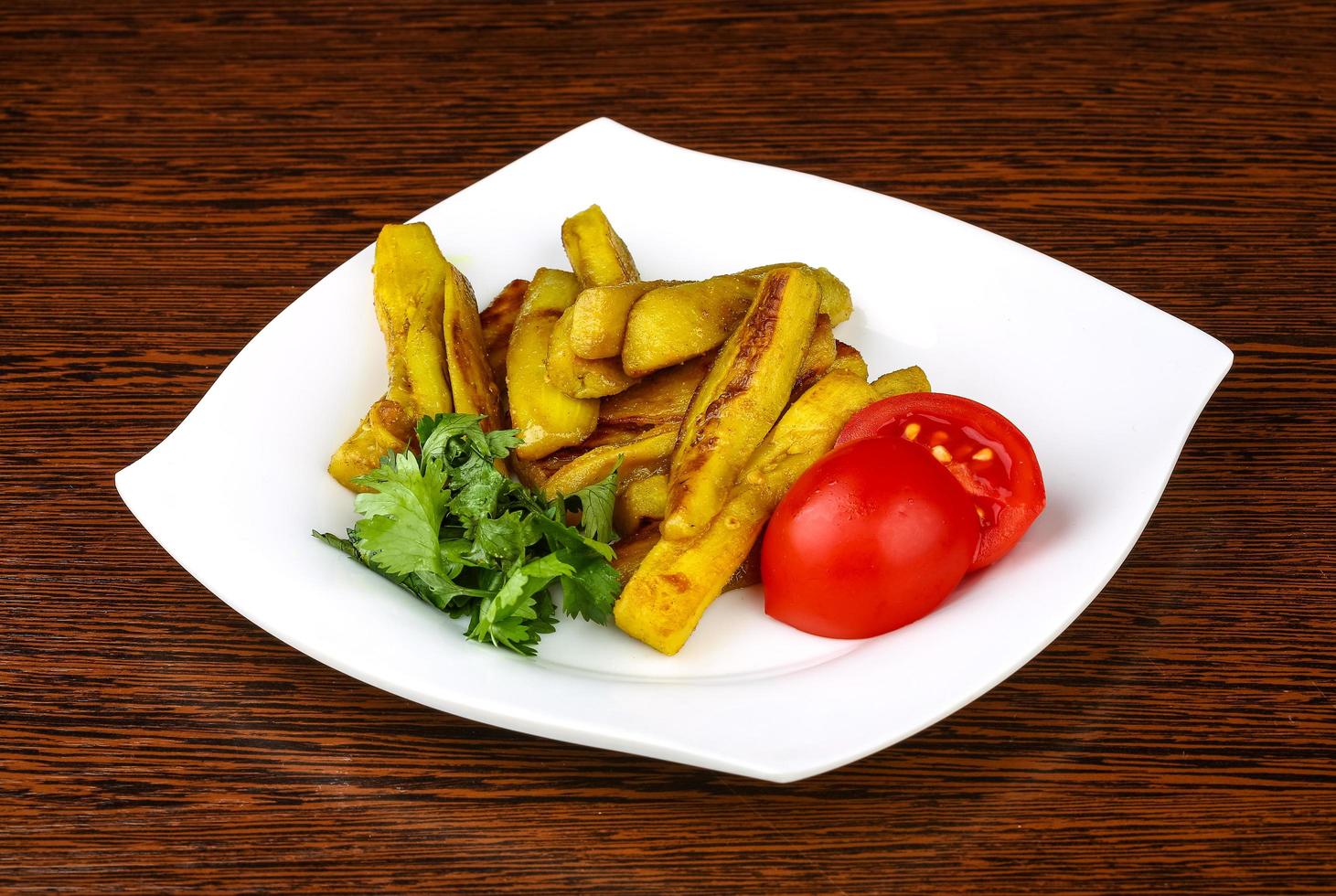 Frid eggplant on the plate and wooden background photo