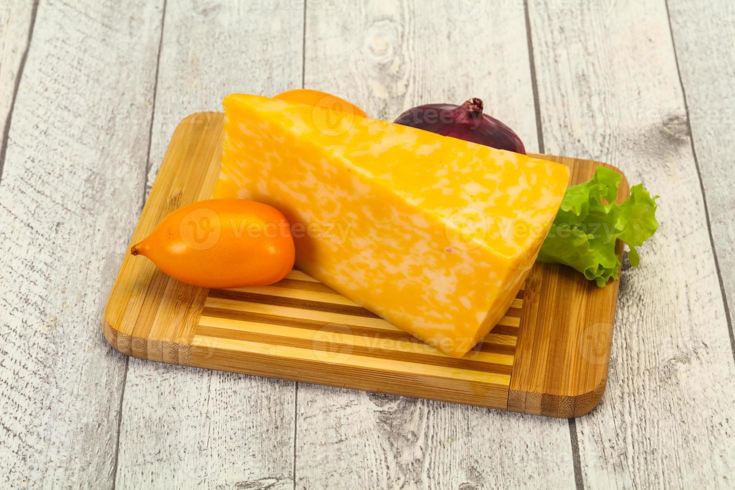 Marble cheese triangle over wooden 12285225 Stock Photo at Vecteezy