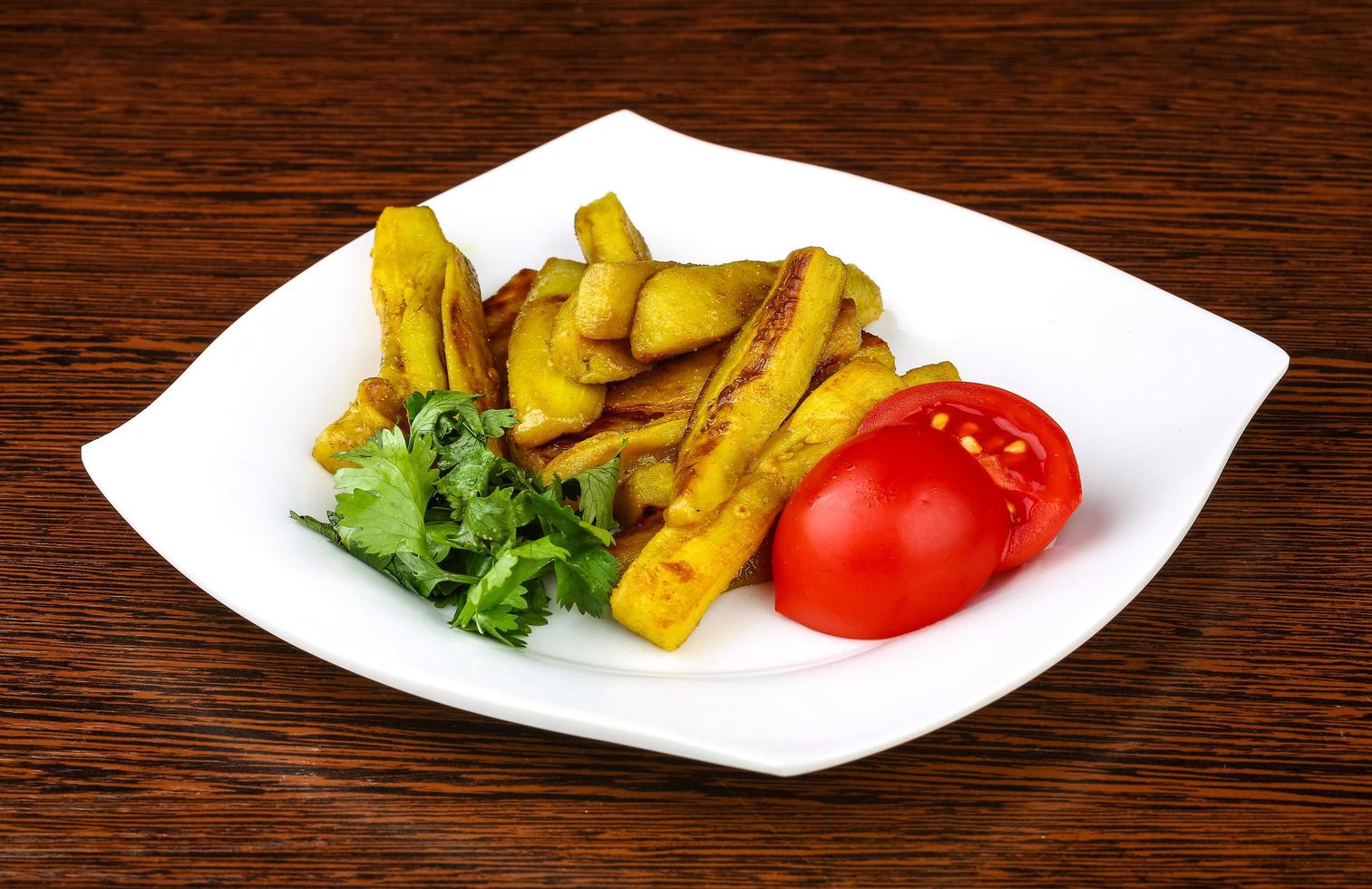 Frid eggplant on the plate and wooden background photo