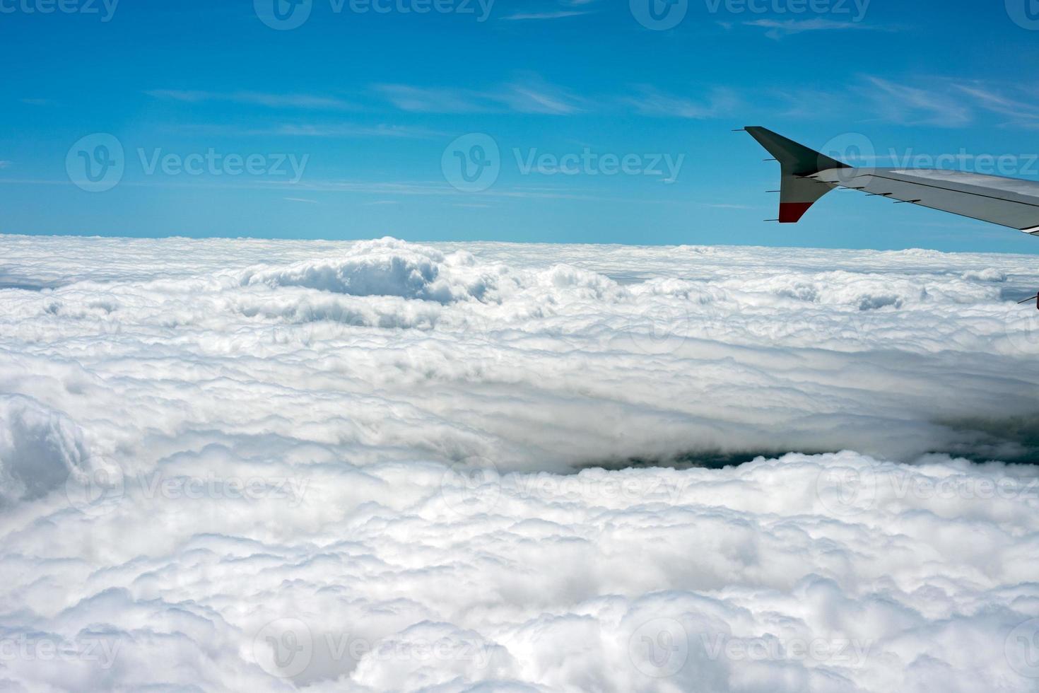 clouds in the sky from airplane window photo