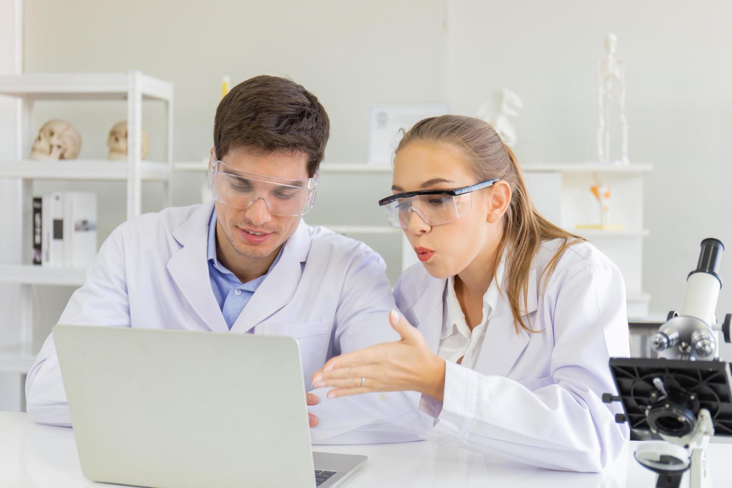 The concept of health care researchers, researchers working in biological science laboratories, young research scientists and male supervisors photo