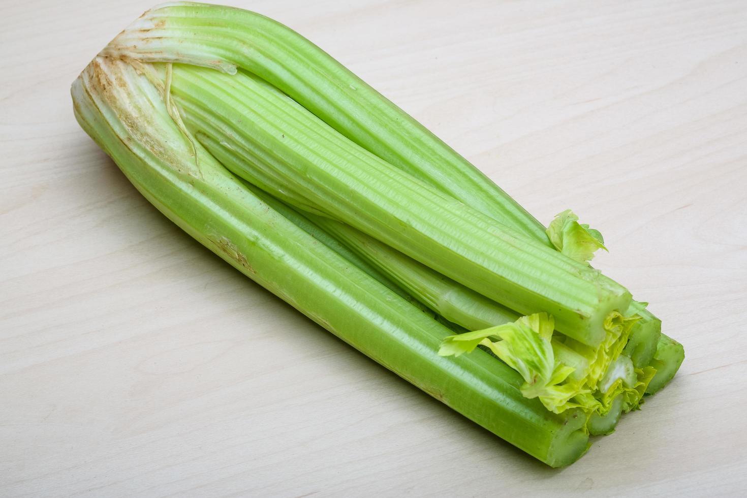 Celery on wooden background photo