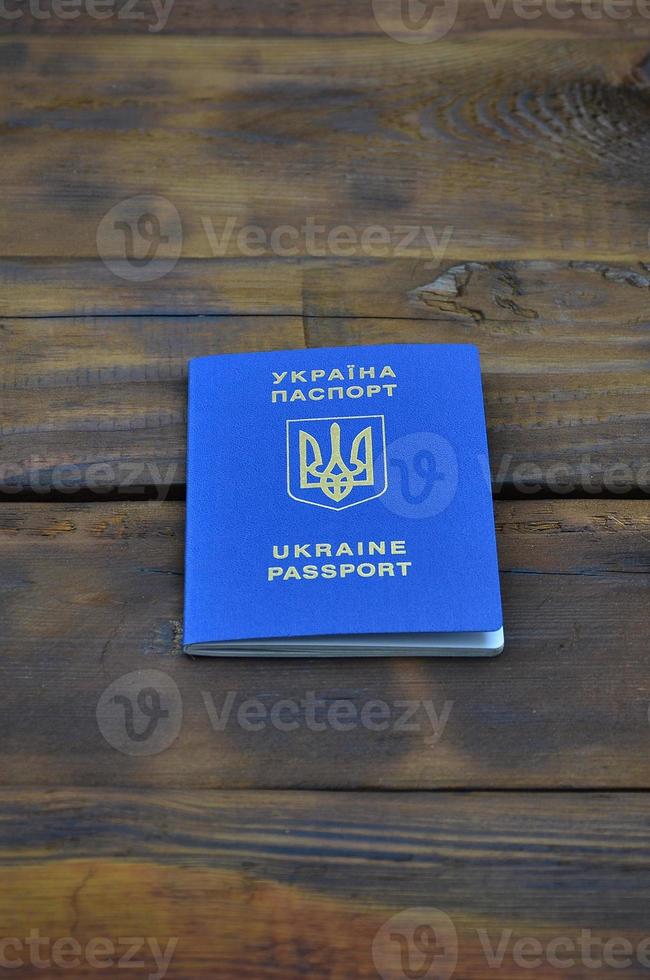 Photo of the Ukrainian foreign passport, lying on a dark wooden surface. The concept of introducing visa-free travel for Ukrainian citizens