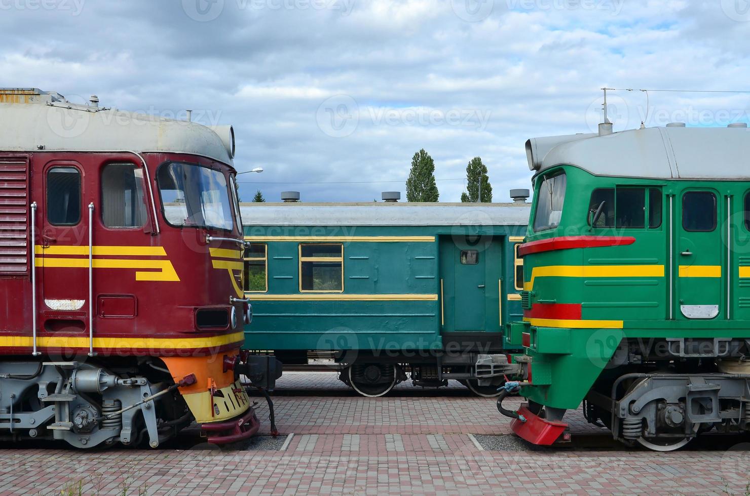 Cabs of modern Russian electric trains. Side view of the heads of railway trains with a lot of wheels and windows in the form of portholes photo
