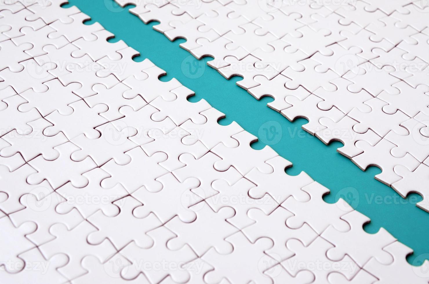 The blue path is laid on the platform of a white folded jigsaw puzzle. Texture image with copy space for text photo