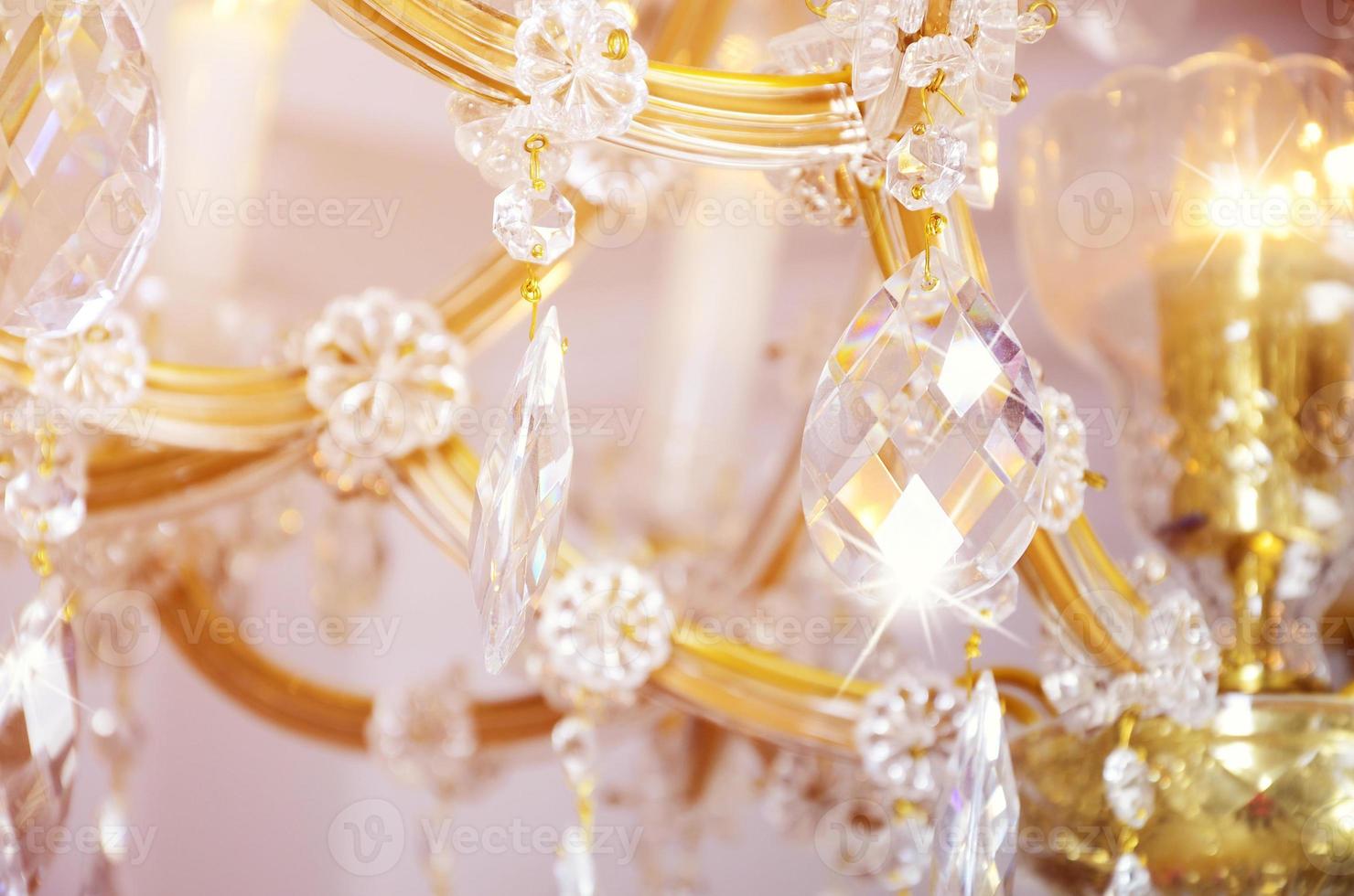Close-up photo of the scenery on the old chandelier. Glass figures shine and reflect light with their faces