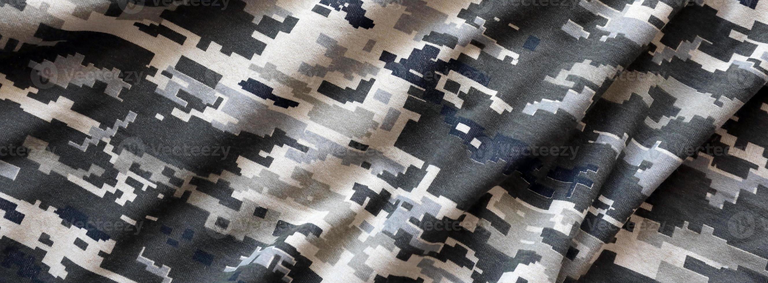 Fabric with texture of Ukrainian military pixeled camouflage. Cloth with camo pattern in grey, brown and green pixel shapes. Official uniform of Ukrainian soldiers photo