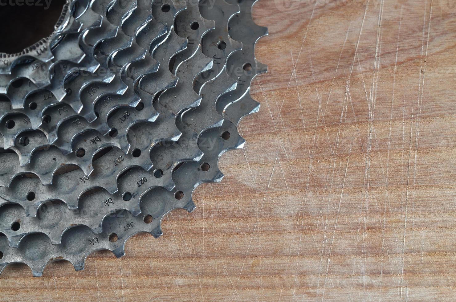 Rear cassette sprocket from a mountain bike lying on a wooden table in a bike shop photo