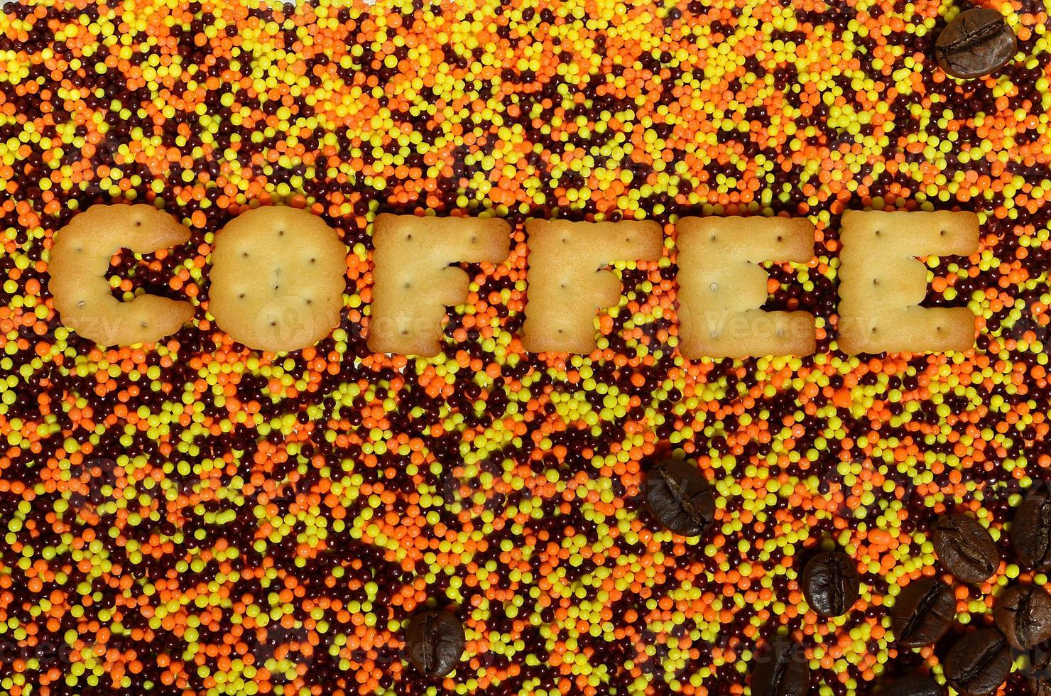 Coffee. The word from the edible letters lies on the glazed powder photo