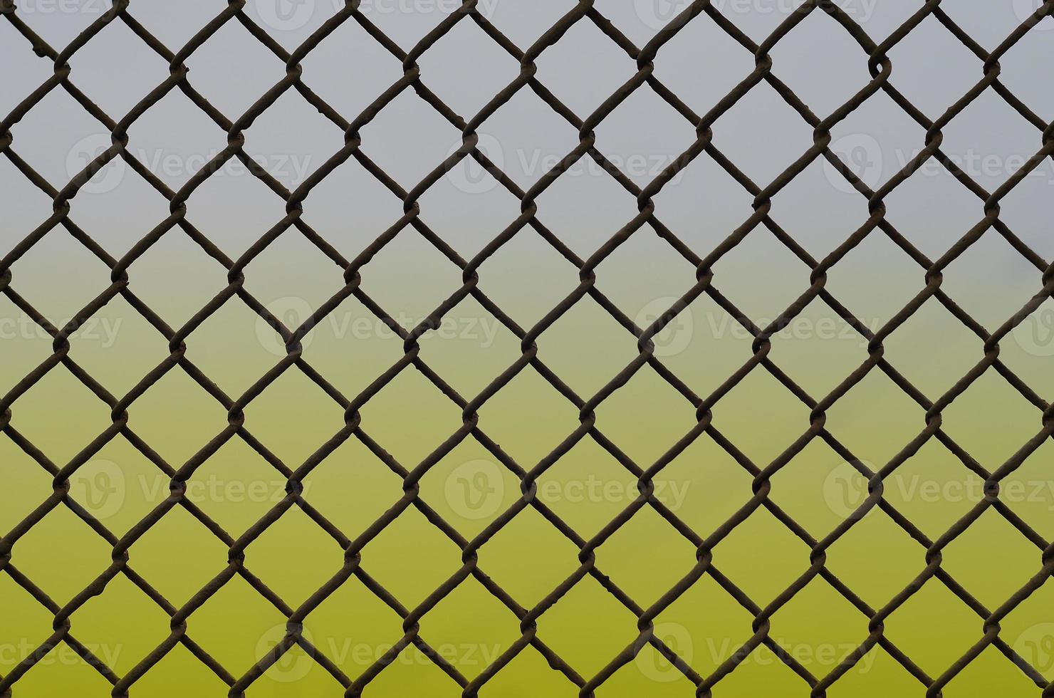 Texture of an old and rusty metal mesh on a neutral colored background photo