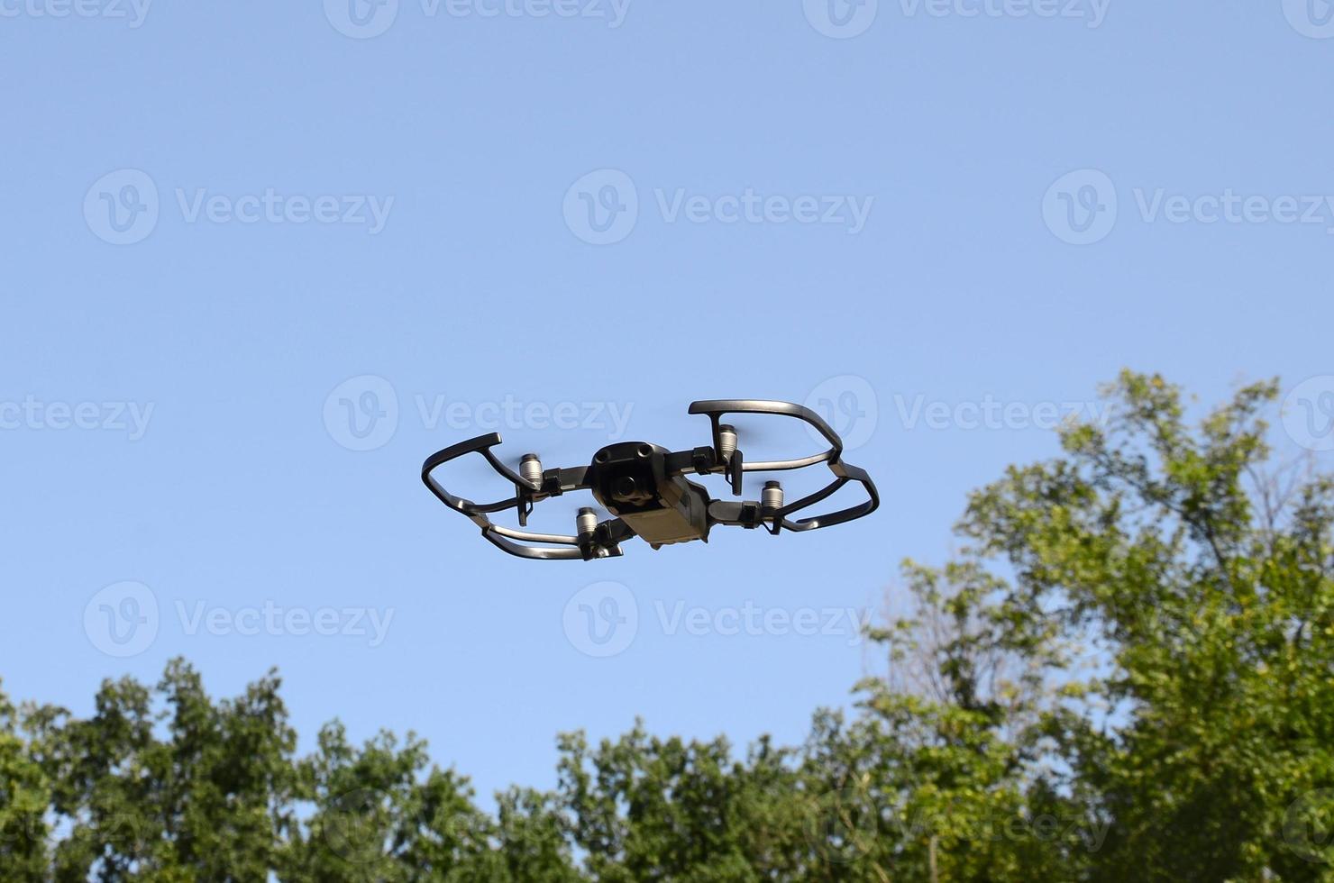 Drone with photocamera take off from land and flying for take aerial photo