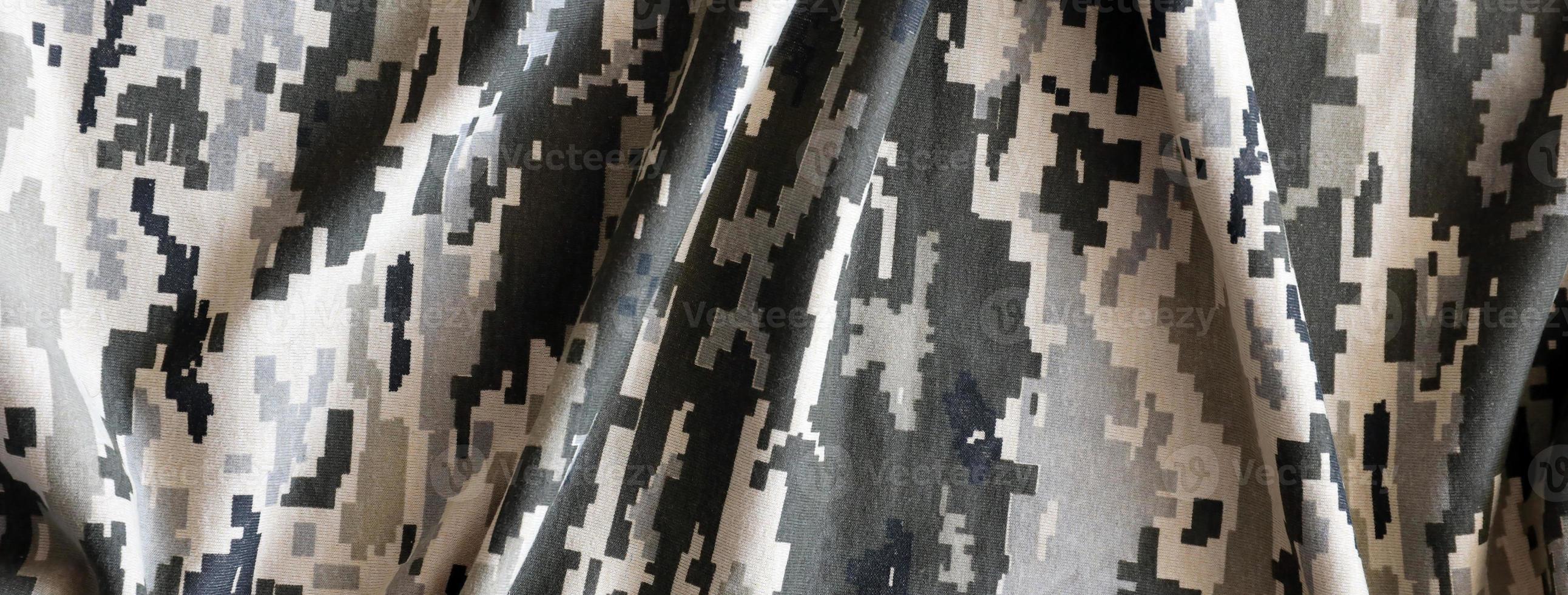 Fabric with texture of Ukrainian military pixeled camouflage. Cloth with camo pattern in grey, brown and green pixel shapes. Official uniform of Ukrainian soldiers photo