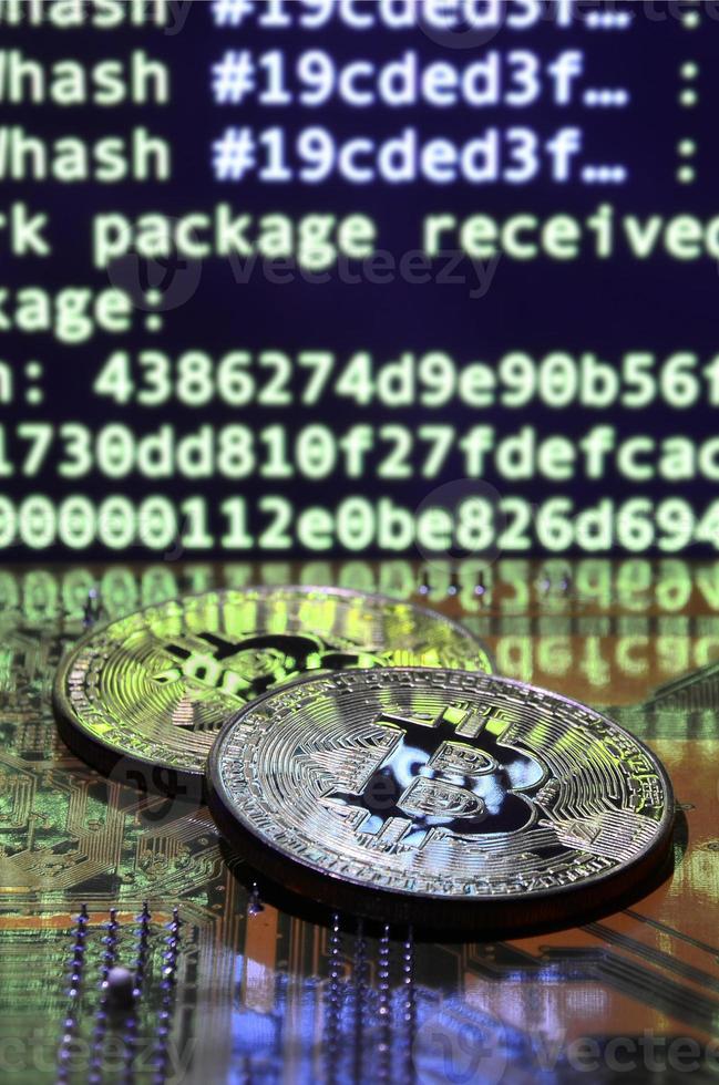 The digital process of cryptocurrency mining by using the GPUs. Bitcoins and video card on a working display and mining screen photo
