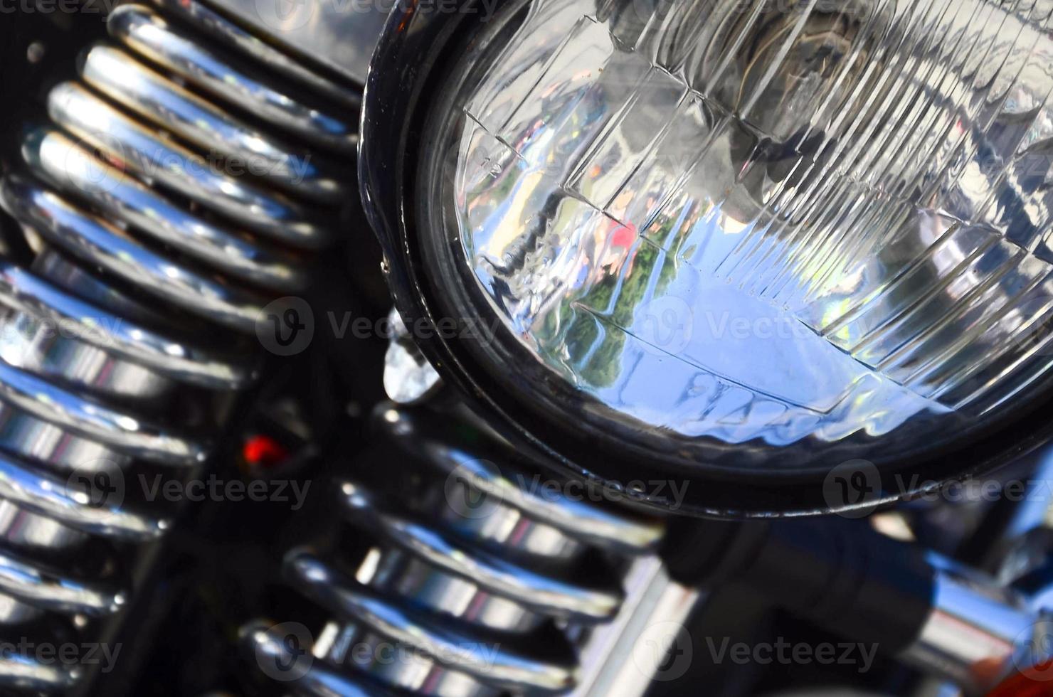 Fragment of chromed shiny lamp of old classic motorbike photo