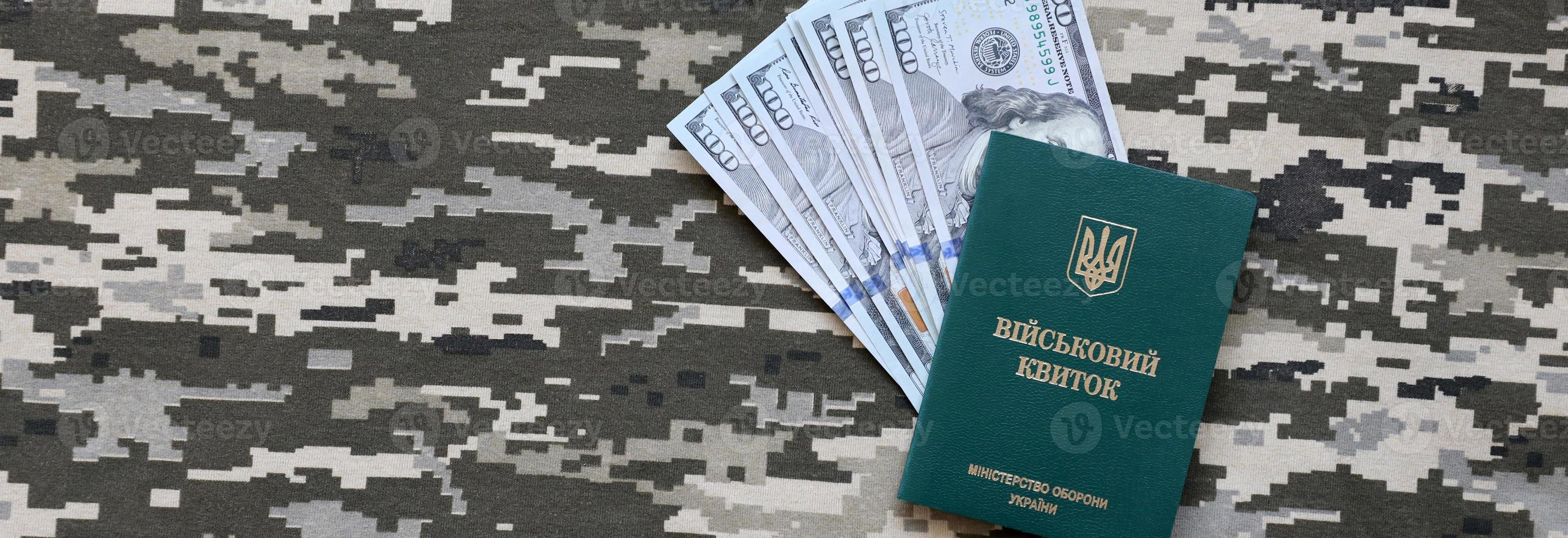 Ukrainian military ID and US dollar bills on fabric with texture of pixeled camouflage. Cloth with camo pattern in grey, brown and green pixel shapes with Ukrainian army personal token. photo