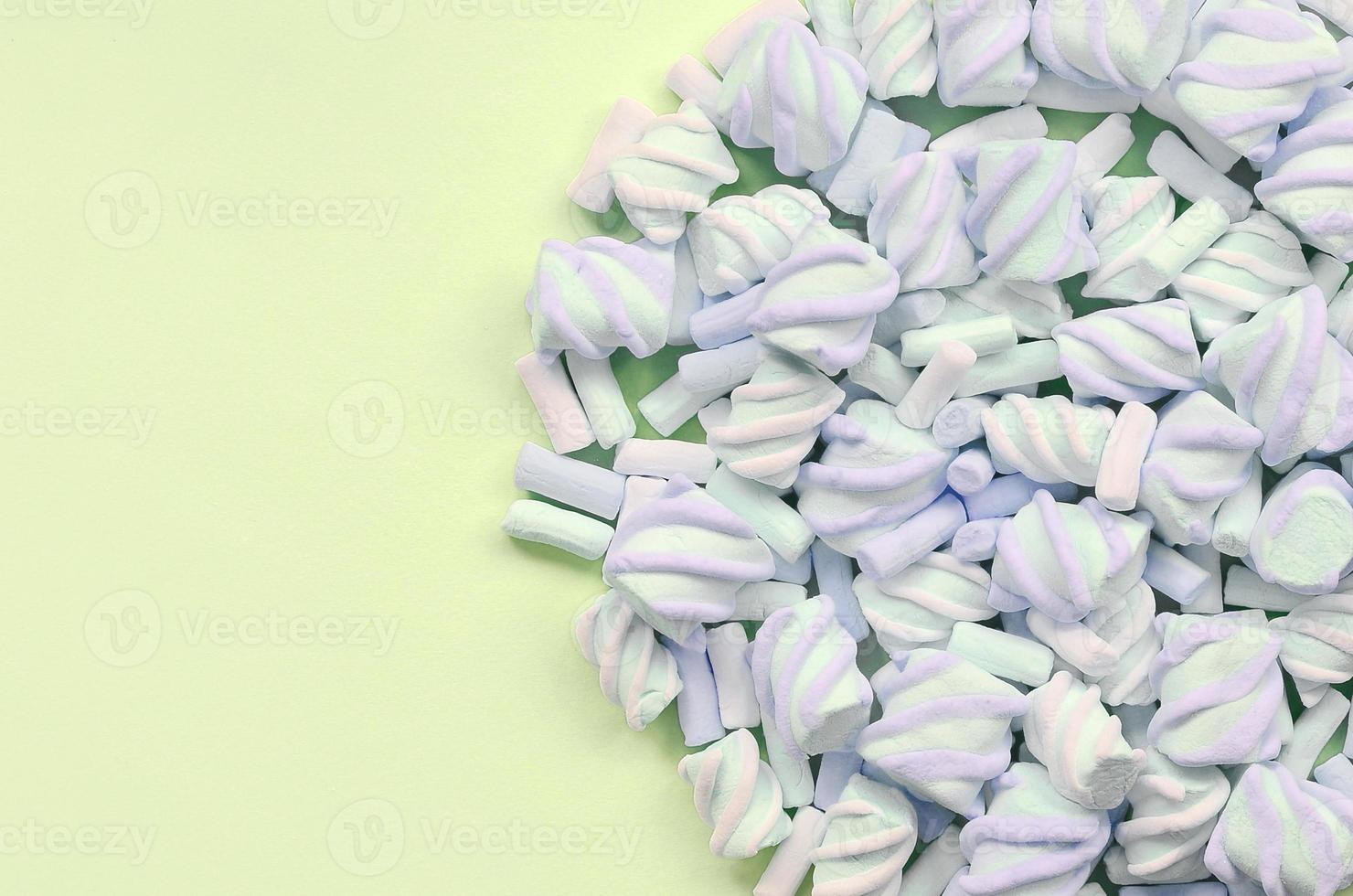 Colorful marshmallow laid out on lime paper background. pastel creative texture photo