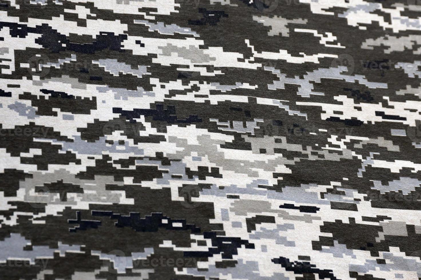 Fabric with texture of Ukrainian military pixeled camouflage. Cloth with camo pattern in grey, brown and green pixel shapes. Official uniform of Ukrainian soldiers photo