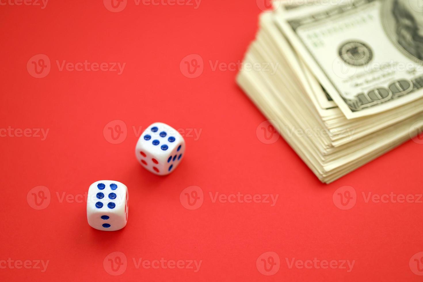 Money, finance and gambling concept. Close up on an American hundred US dollar banknotes and two white dice on top showing the numbers six photo