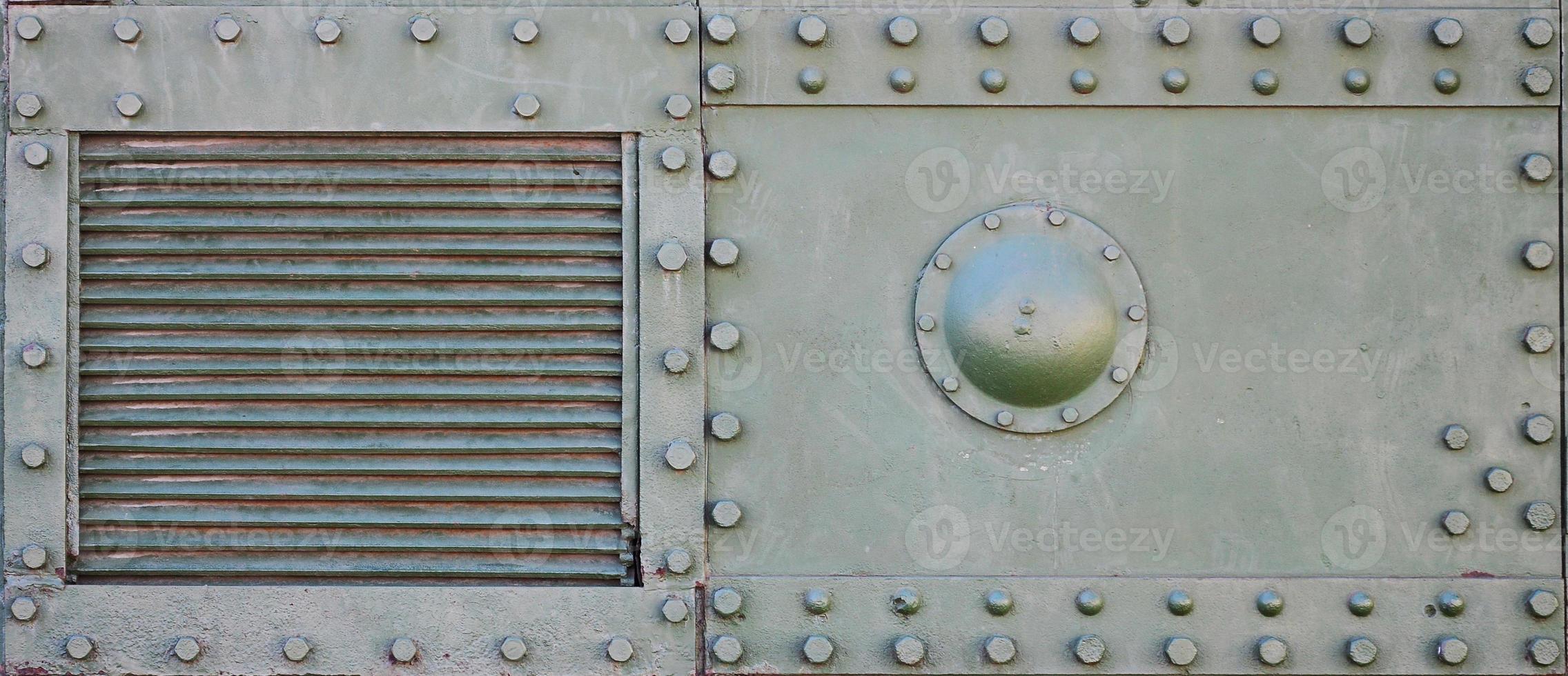 The texture of the wall of the tank, made of metal and reinforced with a multitude of bolts and rivets. Images of the covering of a combat vehicle from the Second World War photo