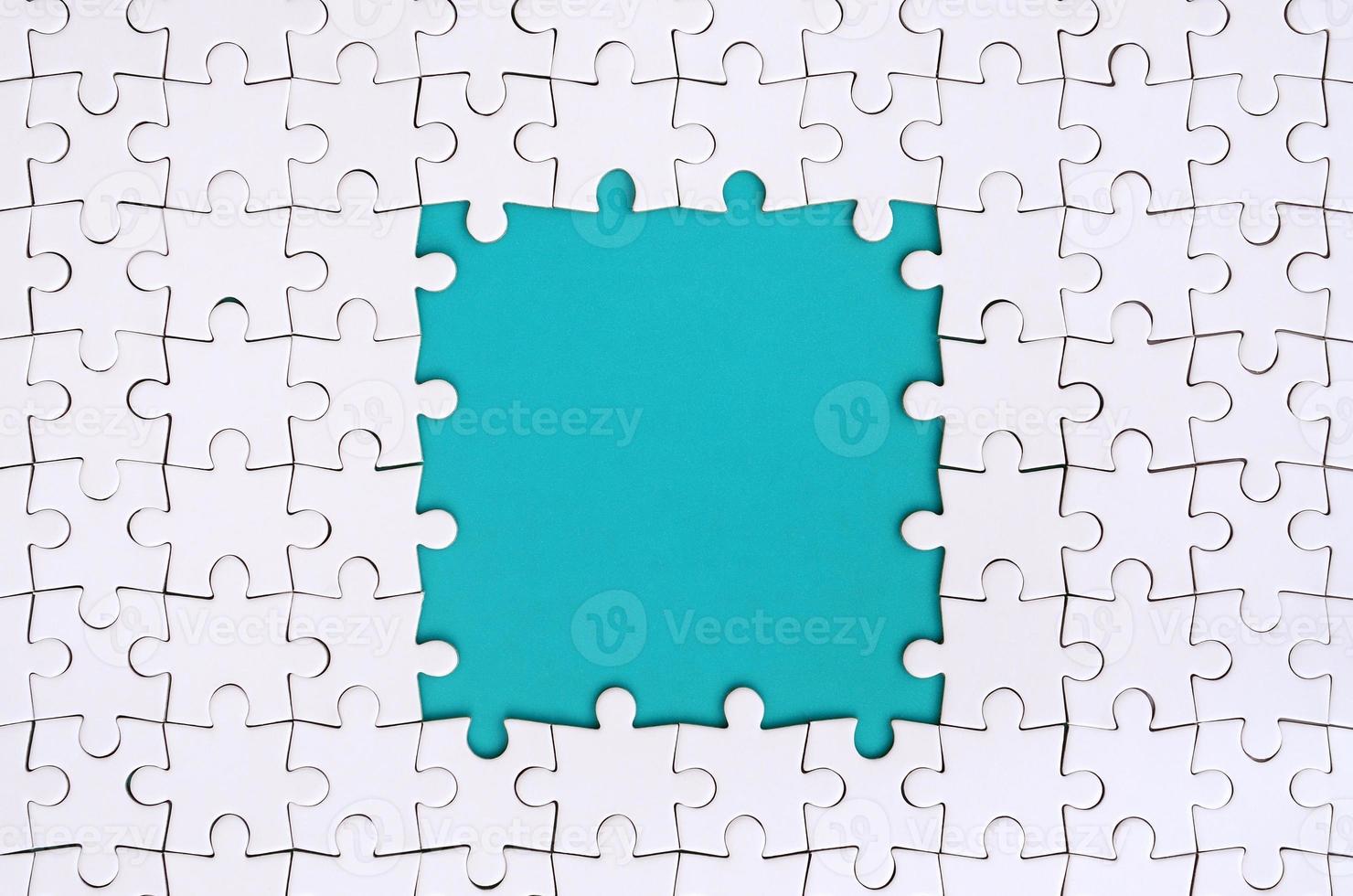 Framing in the form of a rectangle, made of a white jigsaw puzzle around the blue space photo