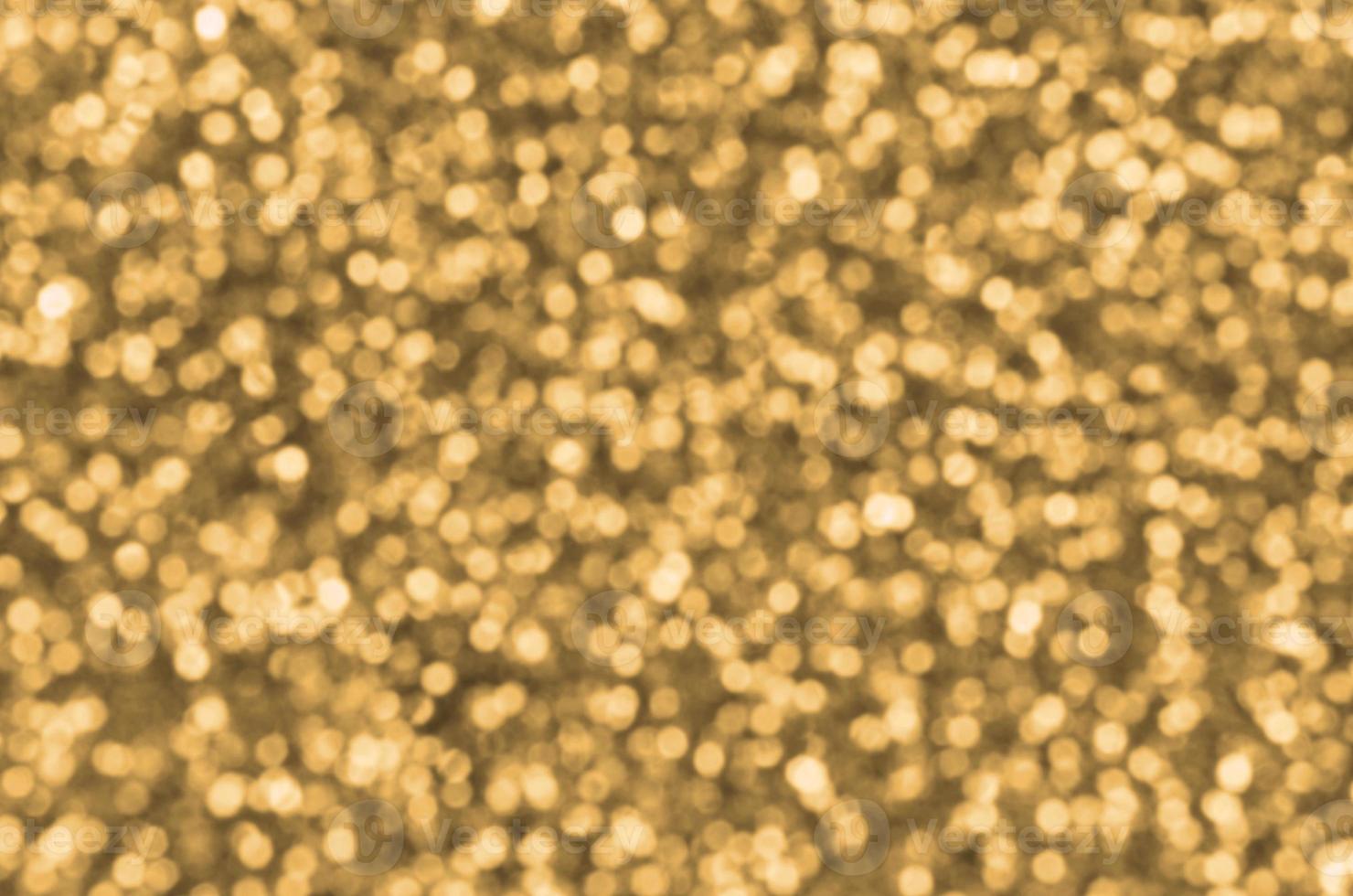 Blurred orange decorative sequins. Background image with shiny bokeh lights from small elements photo