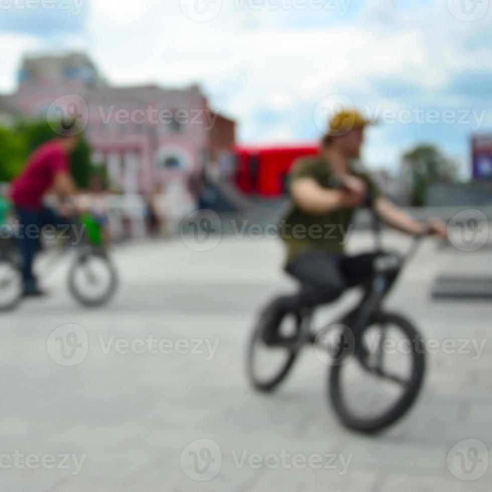 Defocused image of a lot of people with bmx bikes. Meeting of fans of extreme sports photo