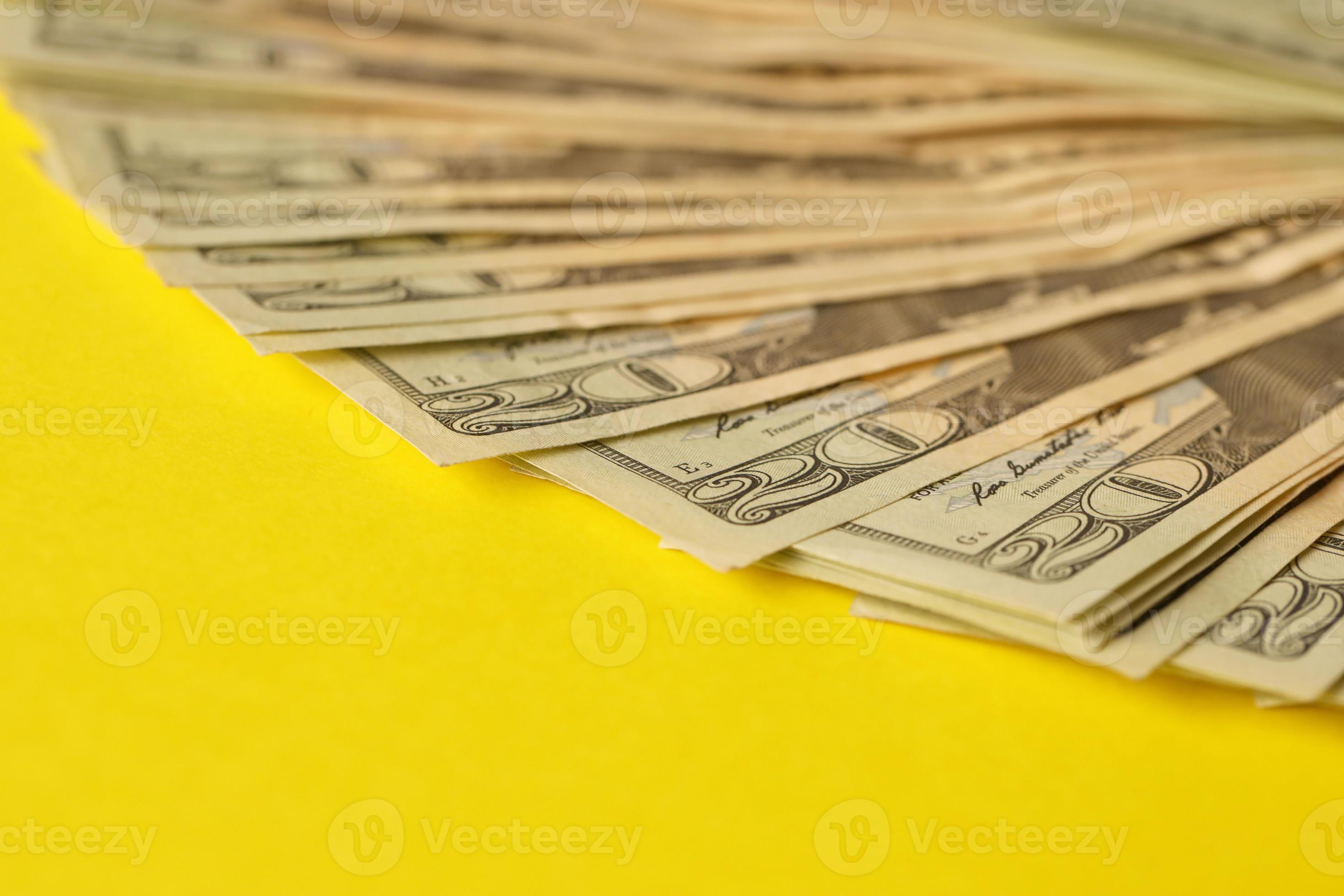 Big amount of old twenty dollar bills on yellow background money