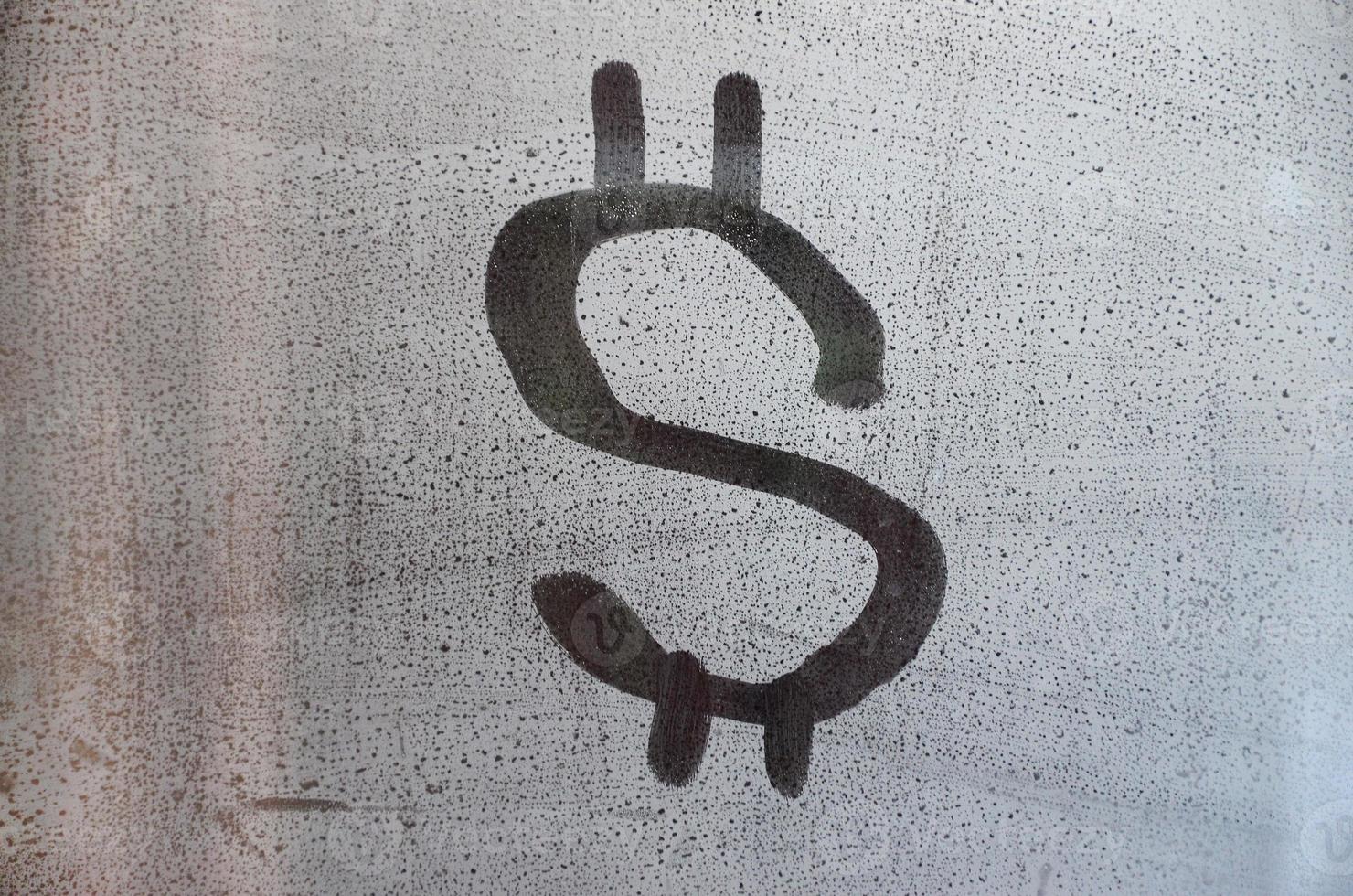 The dollar symbol on the misted sweaty glass. Abstract background image. US money concept photo