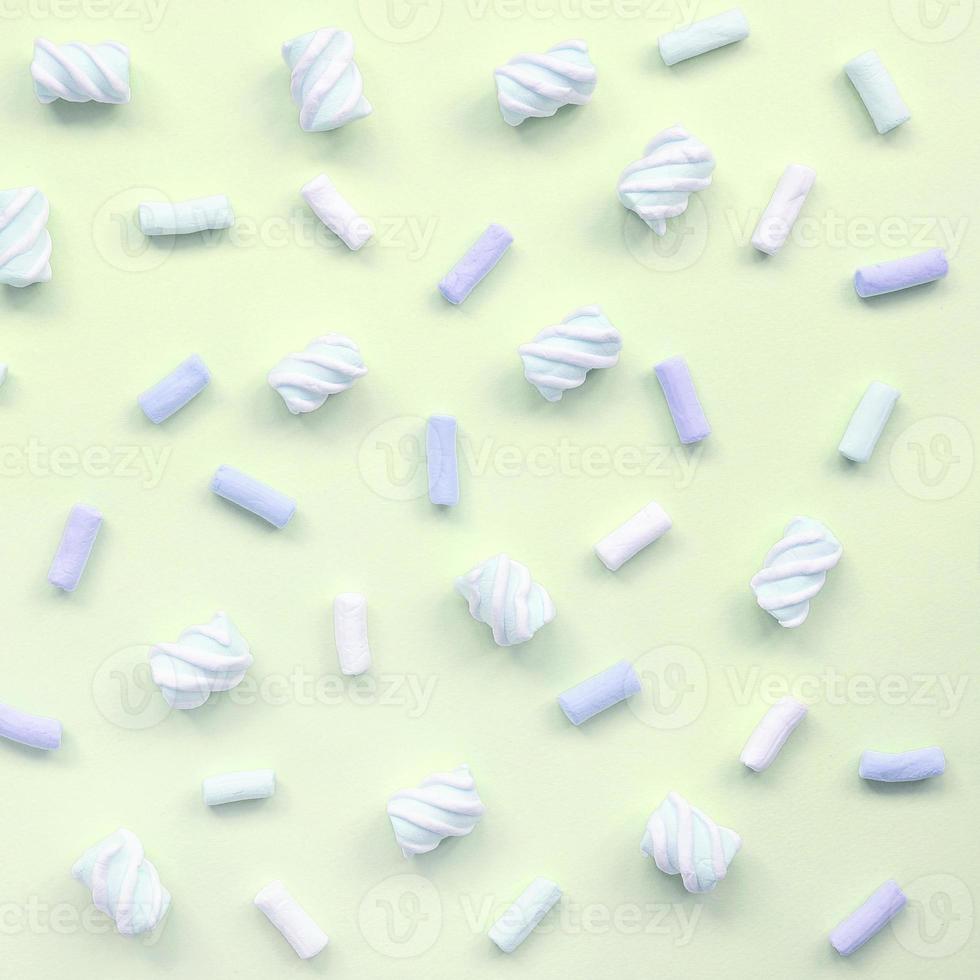 Colorful marshmallow laid out on lime paper background. pastel creative texture photo