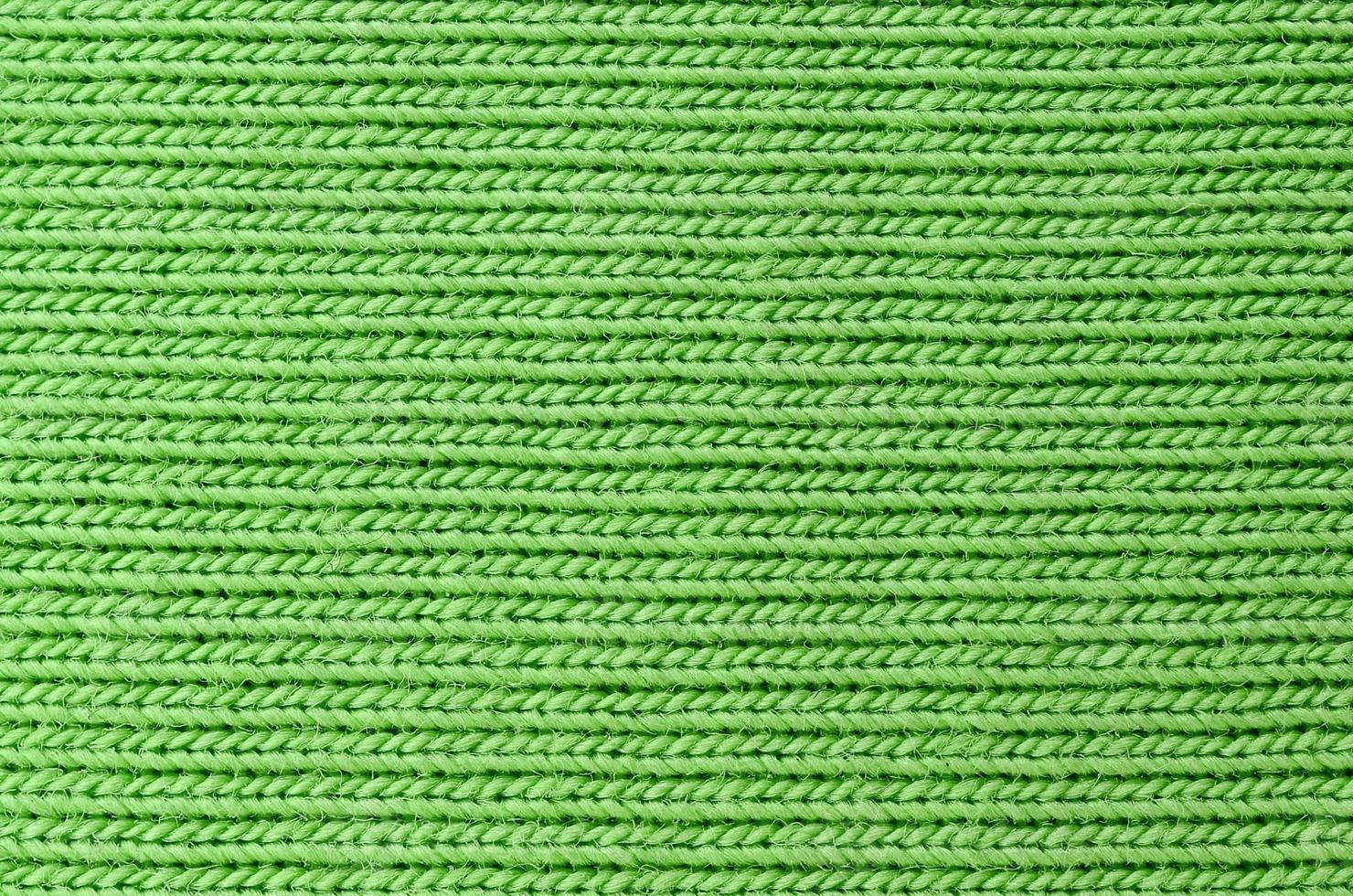 The texture of the fabric is bright green. Material for making shirts and blouses photo