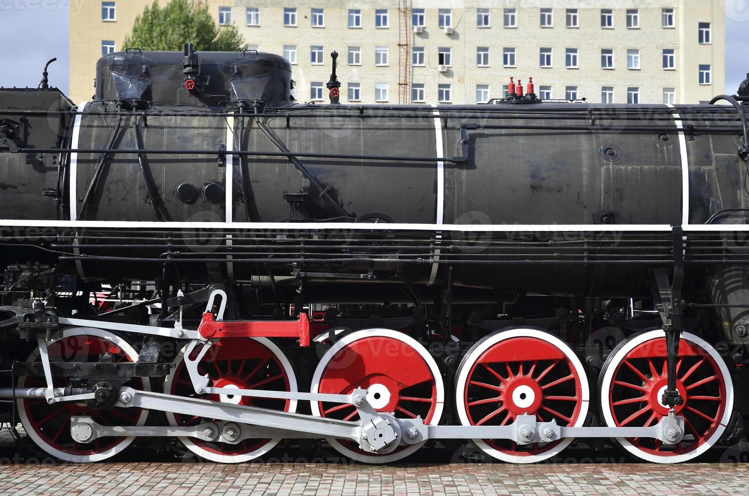 Red wheels of steam train photo