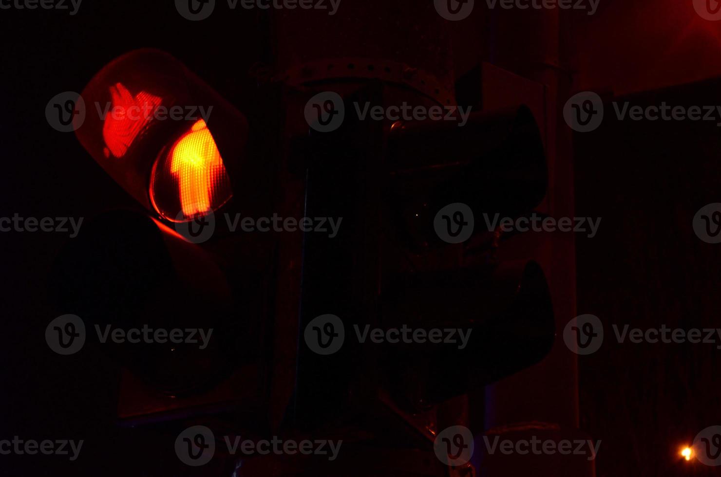 Night photo of a traffic light for pedestrians, which lights up in red