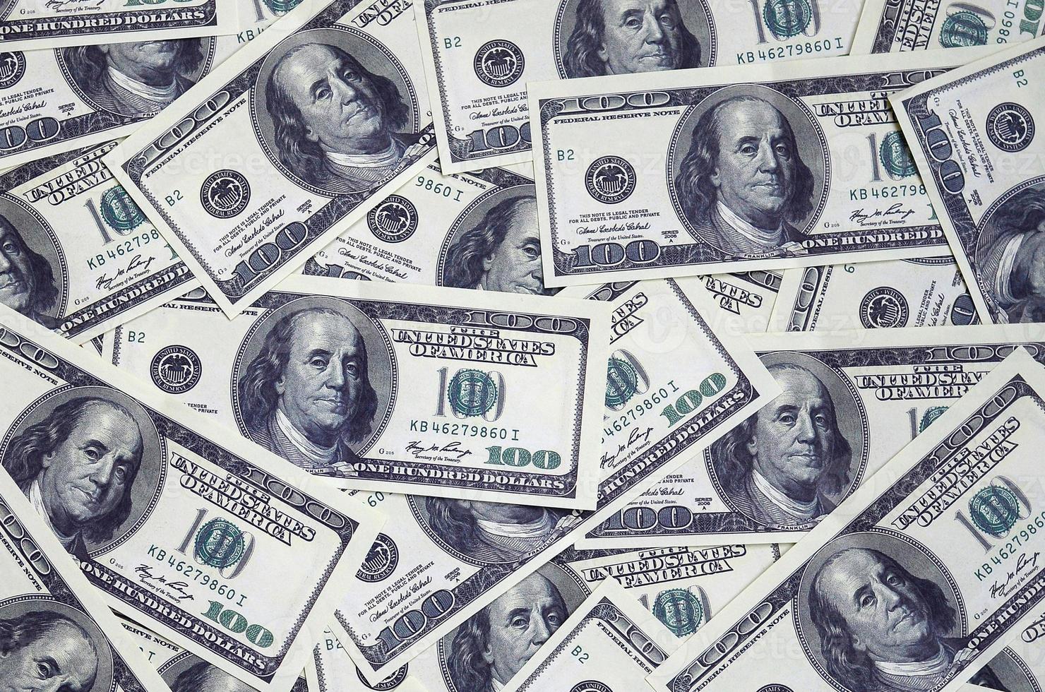 A pile of one hundred US banknotes with president portraits. Cash of hundred dollar bills, dollar background image with high resolution photo