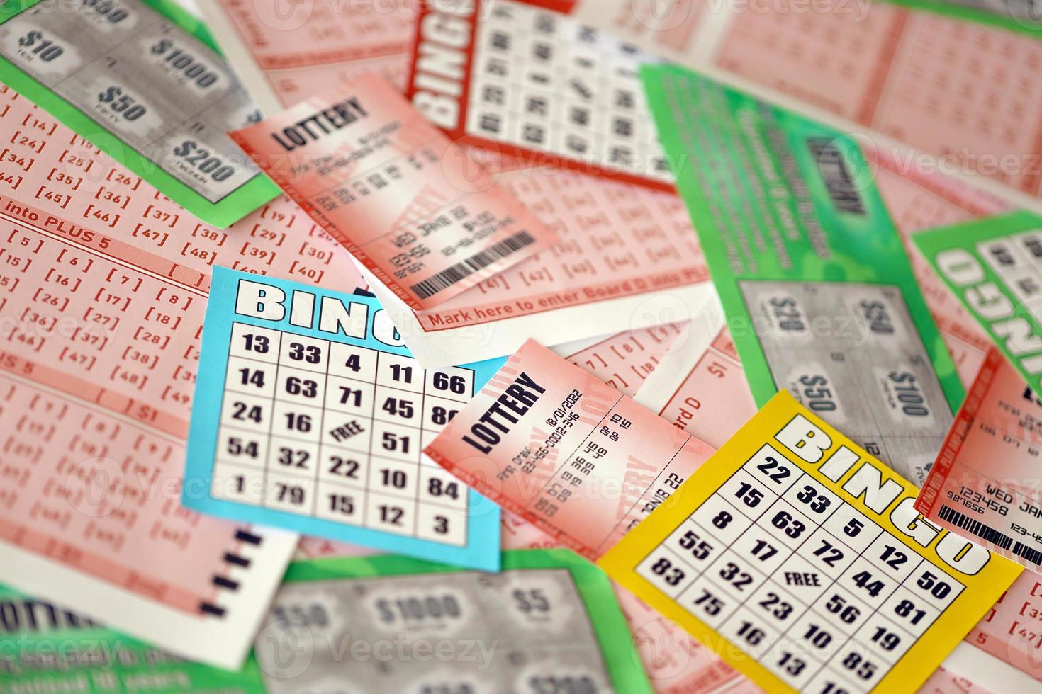 Many used lottery tickets, bills with numbers and bingo playing boards in big pile. Gambling and lottery paper stuff photo