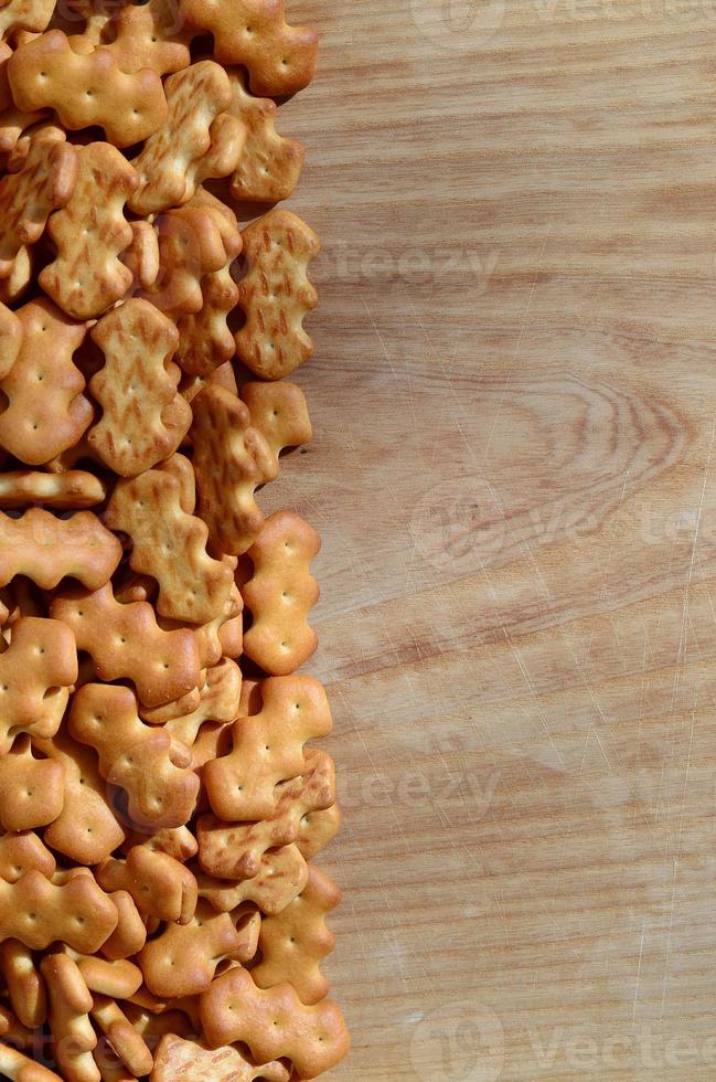 Many salted crackers on a cutting board with copy space photo