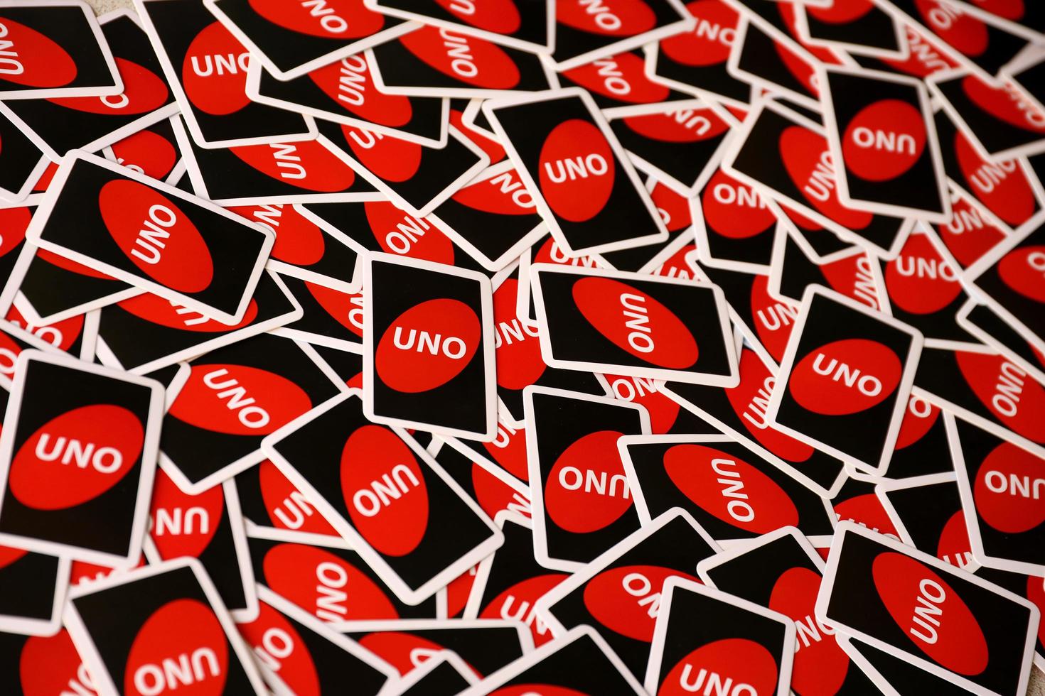 TERNOPIL, UKRAINE - MAY 15, 2022 Many colorful UNO game cards. UNO is an American shedding-type card game that is played with a specially printed deck photo