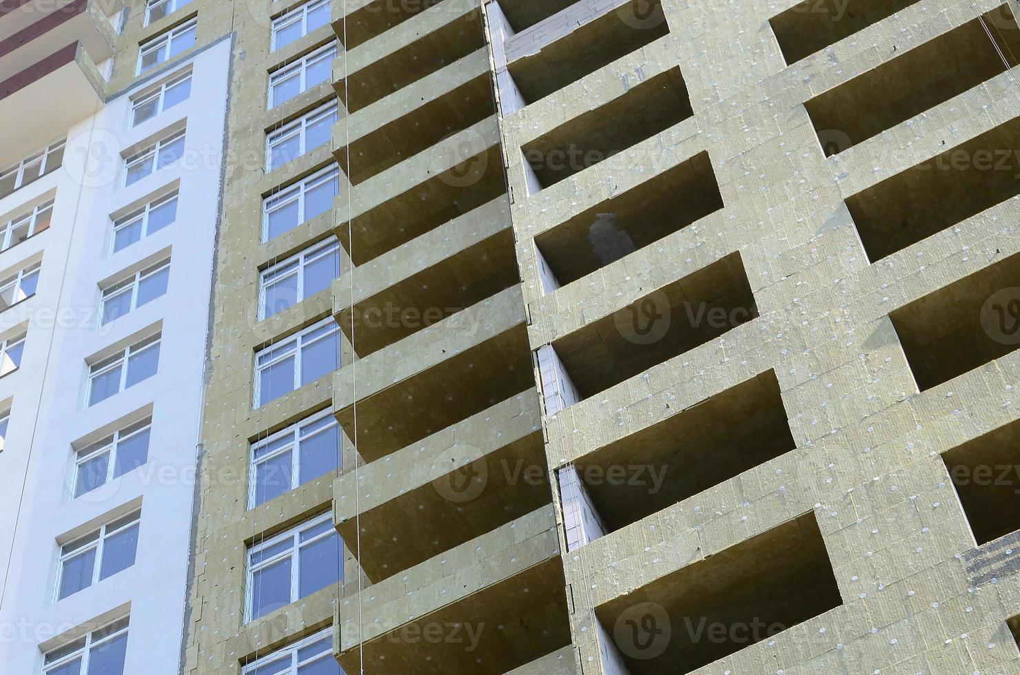 Residential multi store apartement building house facade under construction photo