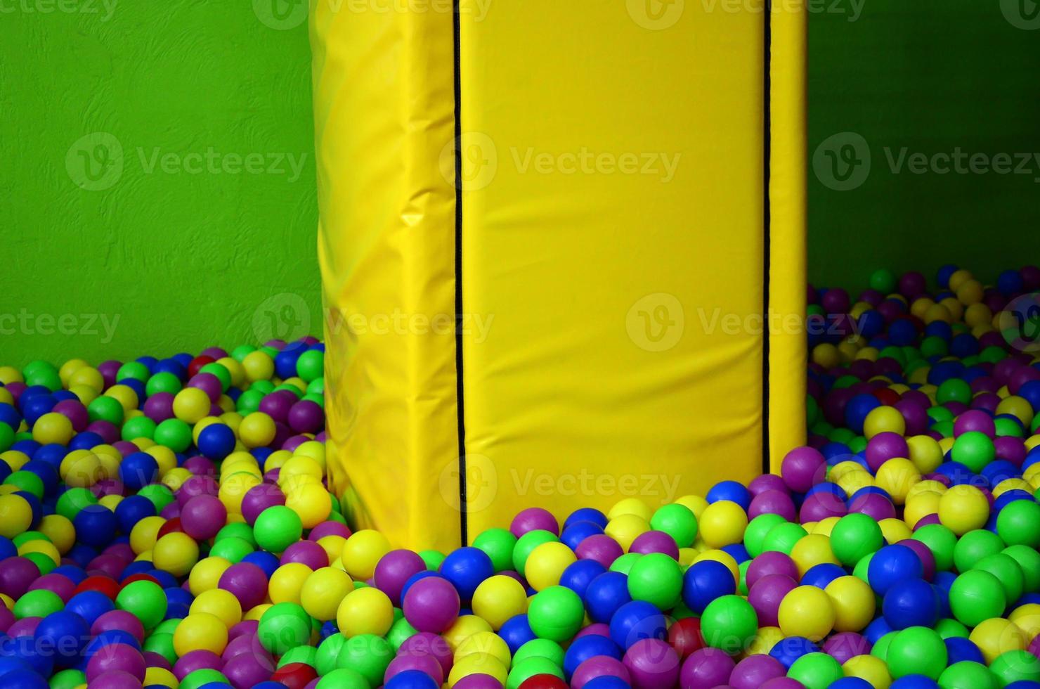 Many colorful plastic balls in a kids' ballpit at a playground photo