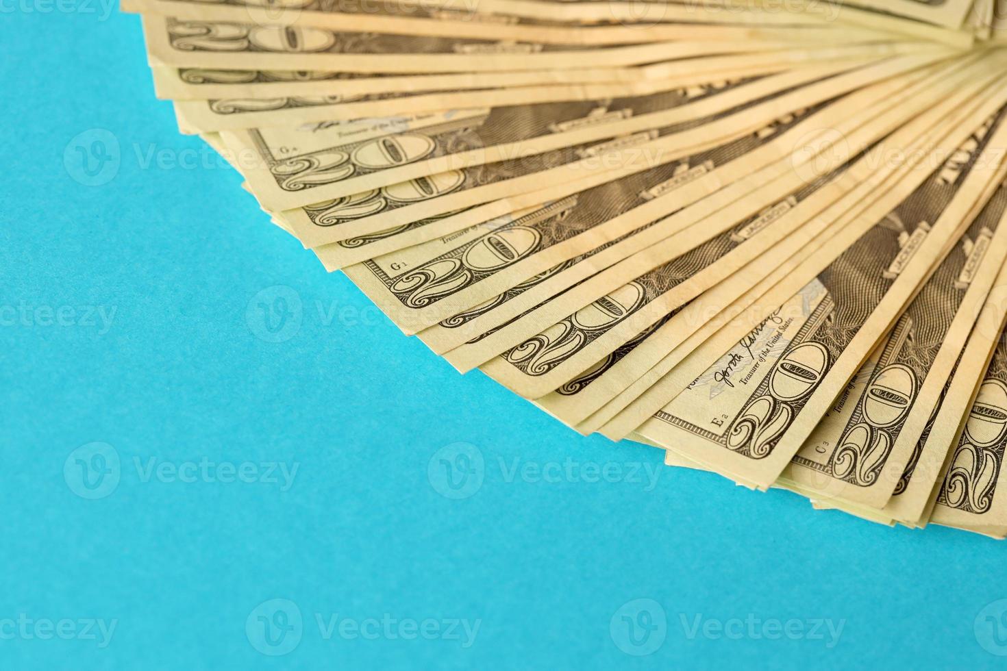 Big amount of old twenty dollar bills on blue background. Money earnings, payday or tax paying period photo